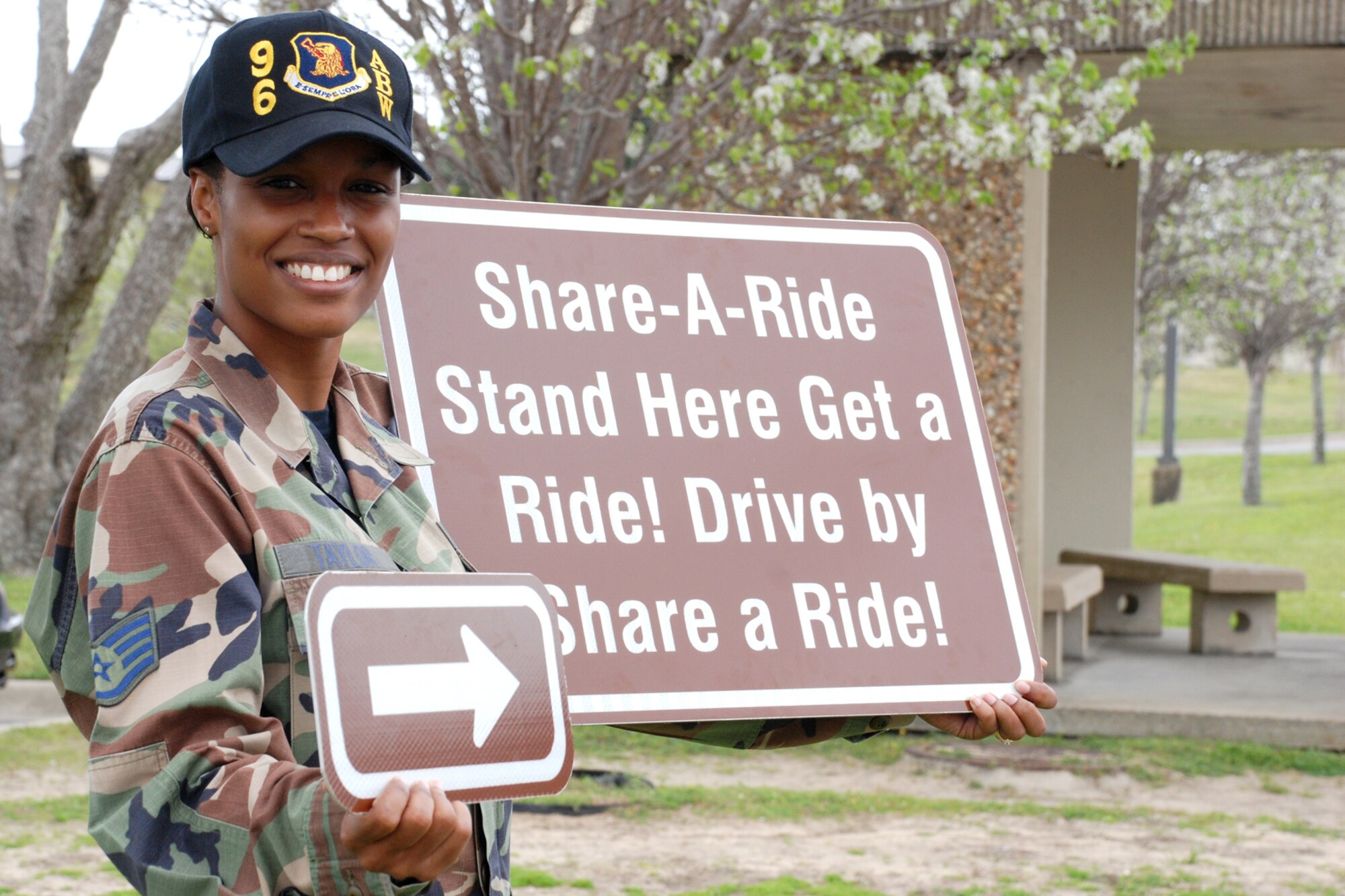 EGLIN AIR FORCE BASE, Fla. -- Staff Sgt. Crystal Taylor, Enlisted Advisory Council president, posses with Share-A-Ride signs that will be placed near stops where Eglin servicemembers can catch a ride from someone passing by. The program, beginning April 1, is based on volunteers stopping and helping out a Team Eglin member by giving them a ride. There are three pick-ups points on base: The Breeze dining facility, the Base Exchange and the Hospital. (U.S. Air Force photo by Staff Sgt. Mike Meares)