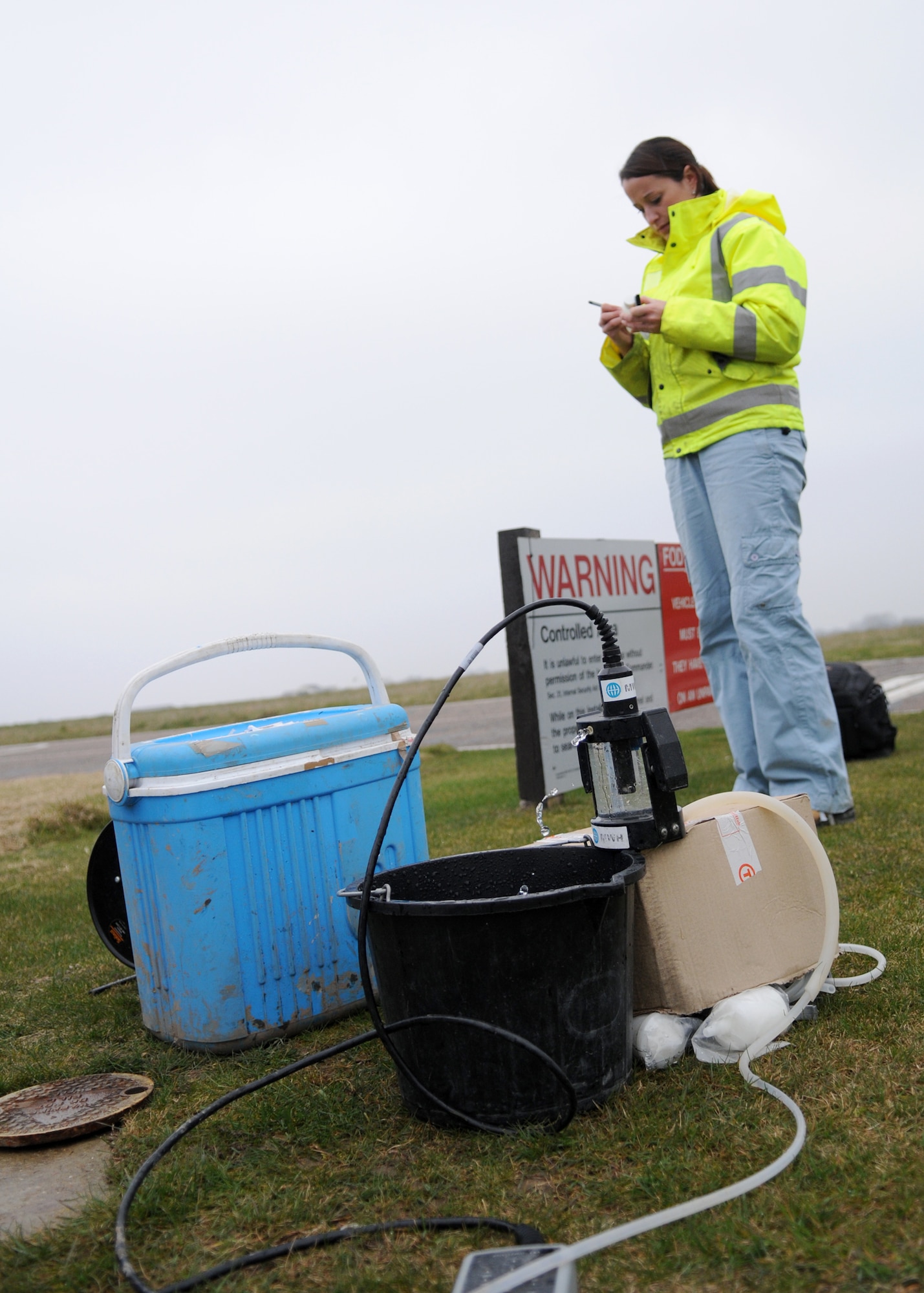 Fiona Carson, an environmental consultant, tests well water for contaminants March 19, 2009, at RAF Mildenhall, England. Ms. Carson pulls 12 samples per well so that each sample may be used to conduct specific tests. Using a water parameter meter, she is able to analyze water ph readings, temperature, and conductivity while also having the ability to determine biological oxygen demand, gas range organic and volatile organic compounds to name a few. (U.S. Air Force photo by Staff Sgt. Jerry Fleshman)