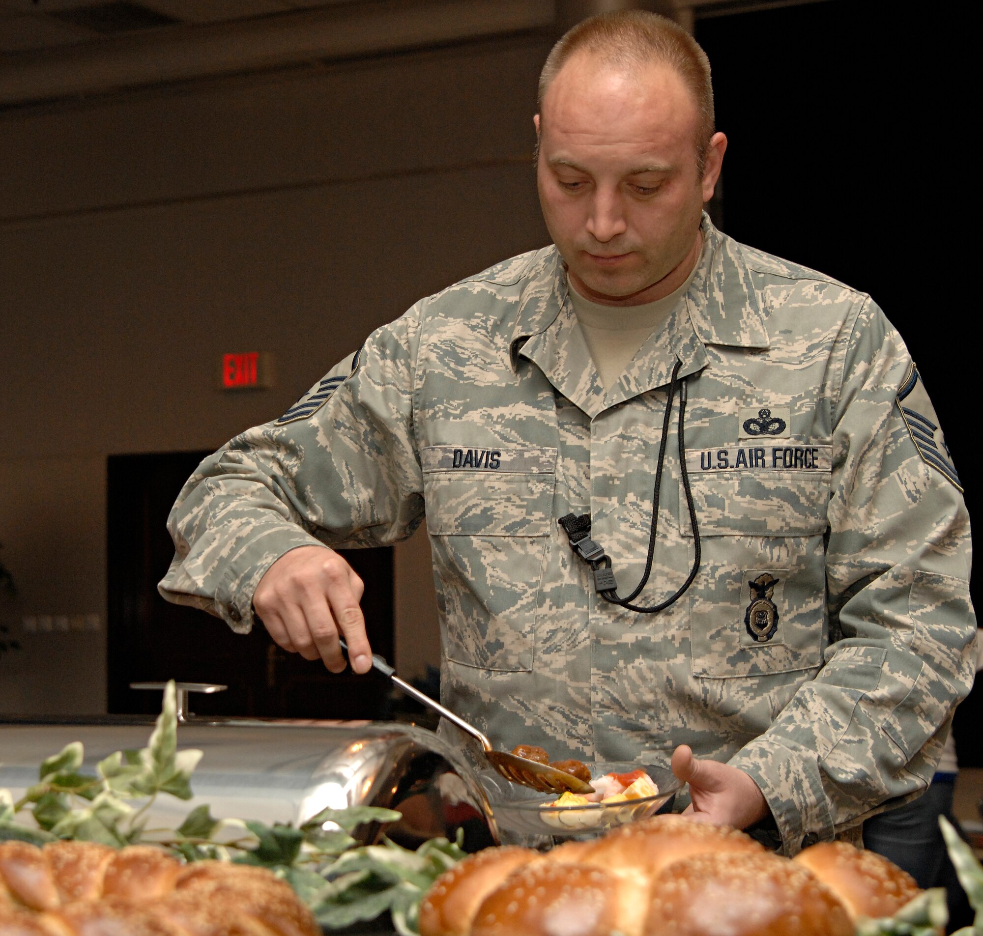 Master Sgt. Joel Davis, 39th Air Base Wing anti-terrorism force protection, dishes out meat balls during a club member appreciation night, Wednesday, March 25, 2009. The event was hosted by the Incirlik Consolidated Club to express gratitude to its members and Chef Jean Marc Laurent, United States Air Forces in Europe command chef, prepared the food, which was free to all club members. (U.S. Air Force photo/Senior Airman Benjamin Wilson, 39th Air Base Wing Public Affairs)