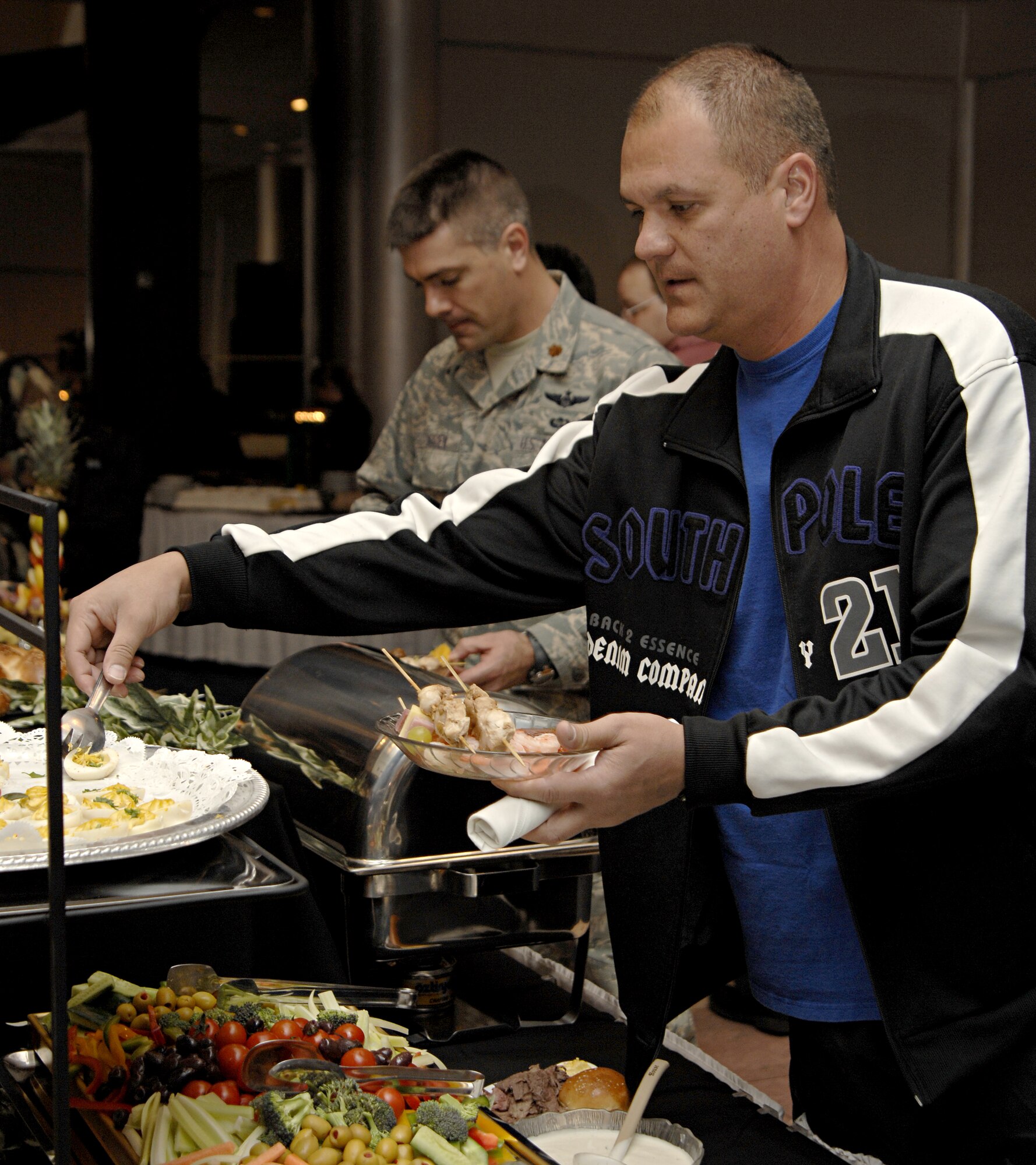 Tech. Sgt. Donald Kane, 39th Maintenance Squadron, Fills his plate during a club member appreciation night, Wednesday, March 25, 2009. The event was hosted by the Incirlik Consolidated Club to express gratitude to its members and Chef Jean Marc Laurent, United States Air Forces in Europe command chef, prepared the food, which was free to all club members. (U.S. Air Force photo/Senior Airman Benjamin Wilson, 39th Air Base Wing Public Affairs)