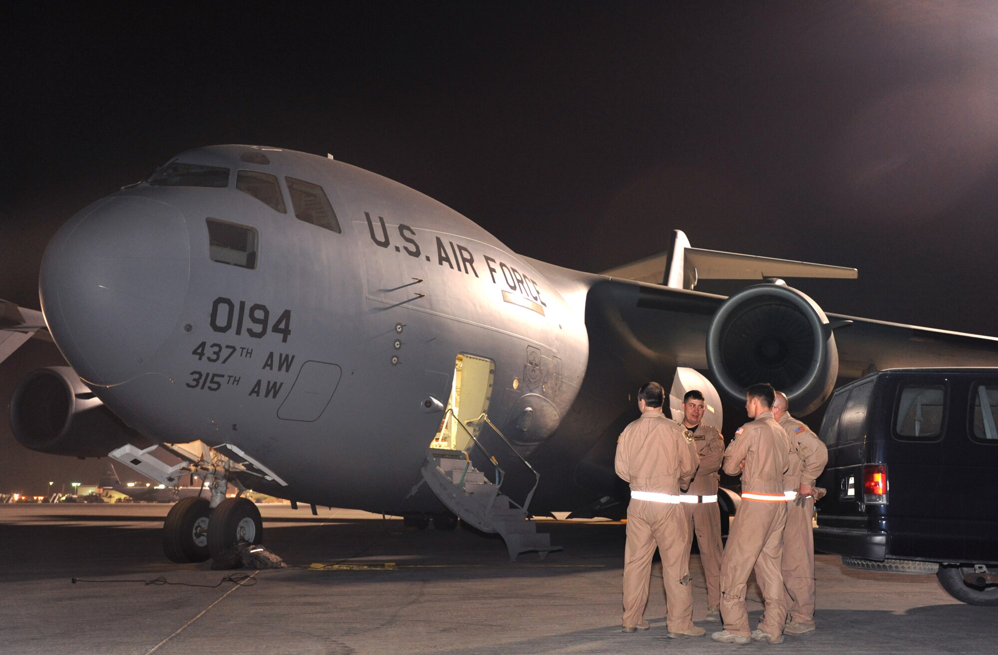 Part of the crew that helped guide a KC-135R Stratotanker, which had lost navigational capability over Afghanistan, to a safe landing at Bagram Air Base, Afghanistan on March 16, gather in front of their C-17 Globemaster III here, March 21, 2009.  All are with the 816th Expeditionary Airlift Squadron and are deployed at an undisclosed location in Southwest Asia from Charleston Air Force Base, S.C., in support of Operations Iraqi and Enduring Freedom and Combined Joint Task Force - Horn of Africa.  (U.S. Air Force Photo by Staff Sgt. Joshua Garcia/released)