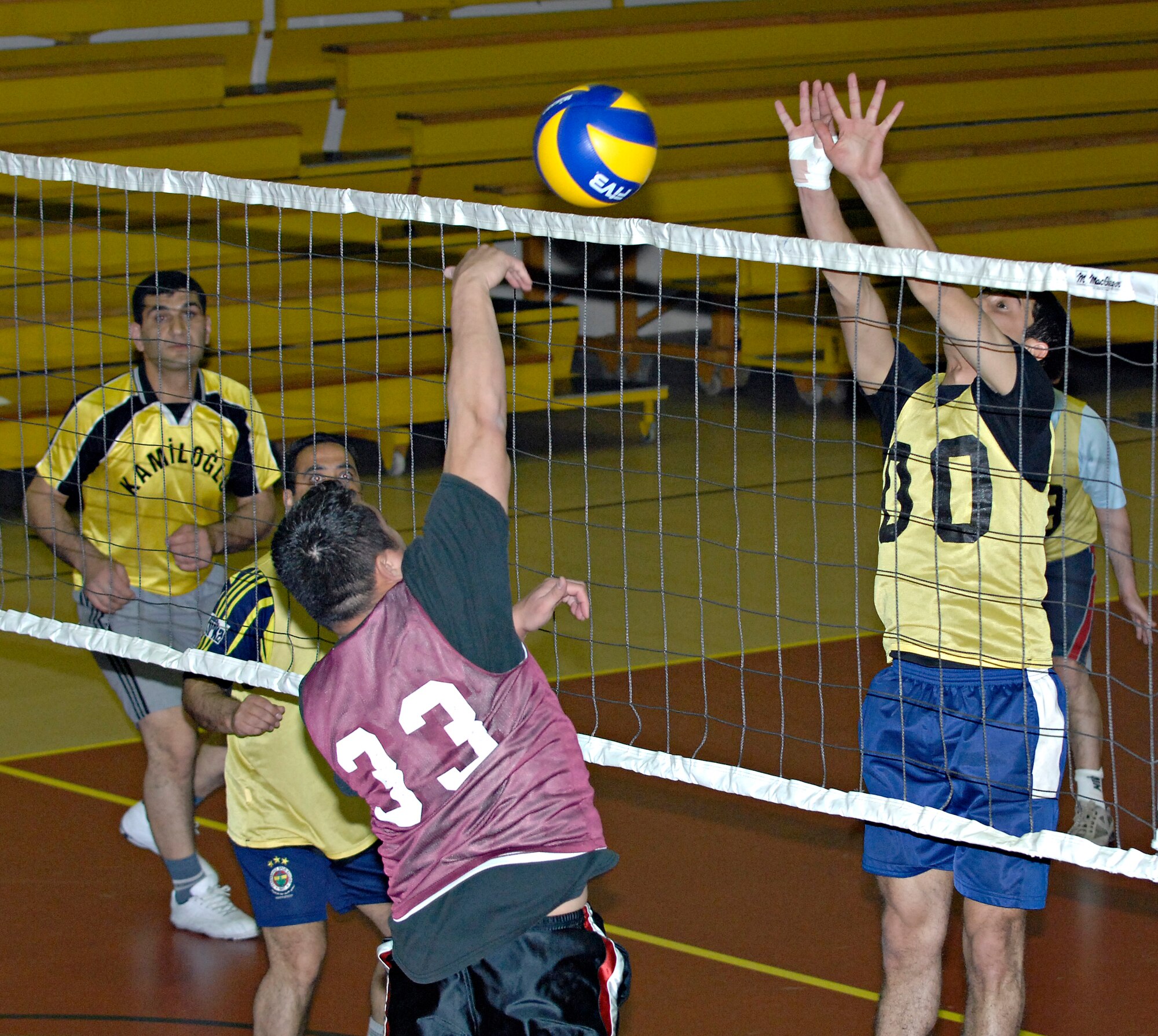 Sukru, Maintenance 2, attemps to block a ball spiked by Philip Santos, Team 2, during a volleyball game, Tuesday, March 24, 2009 at the Incirlik Fitness Center. Maintenance 2, made up of personnel from the Turkish air force, beat Team 2, made up of personnel from the U. S. Air Force, with a score of 25-8. The U.S. and Turkish Air Forces have volleyball matches scheduled for 12:00 p.m. in the Incirlik Fitness Center all week increase the good relations between the U.S. Air Force and their host nation counterparts. (U.S. Air Force photo by Senior Airman Benjamin Wilson, 39th Air Base Wing Public Affairs)