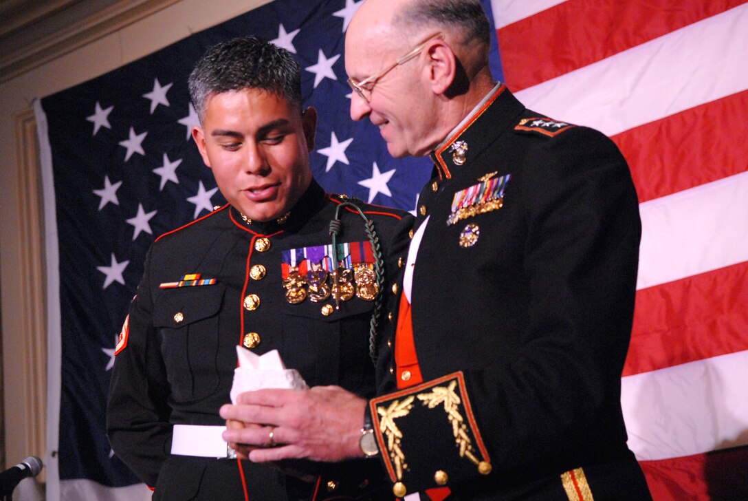 U.S. Marine Lt. Gen. Duane Thiessen, right, the deputy commandant of the Marine Corps for programs and resources, presents U.S. Marine Staff Sgt. Joseph Perez, left, with a United Service Organizations of Metropolitan Washington Special Salute award during the USO-Metro 27th Annual awards dinner at the Ritz Carlton Hotel in Arlington, Va., March 25, 2009.