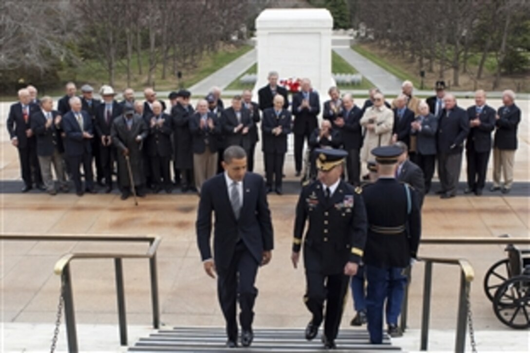 President Barack Obama and Army Maj. Gen. Richard J. Rowe, commander of the Military District of Washington, walk away from the Tomb of the Unknowns as 35 Medal of Honor recipients applaud following a wreath-laying ceremony on Arlington National Cemetery, Va., March 25, 2009. The president joined the recipients of the nation's highest military decoration for a National Medal of Honor Day event at the cemetery.