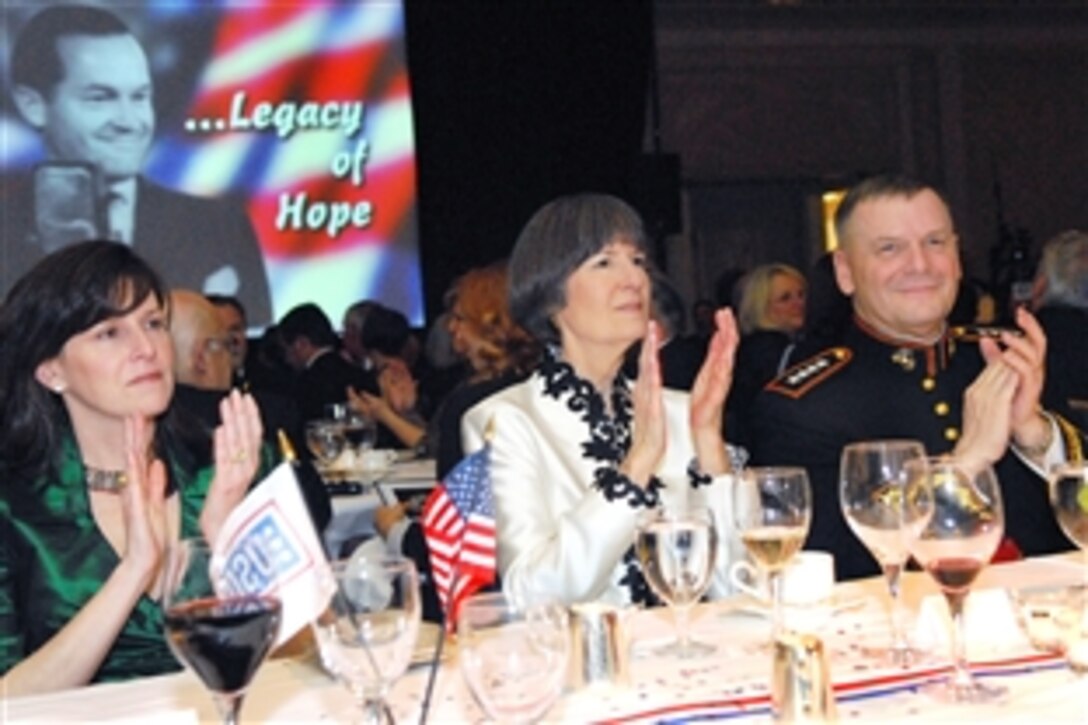 U.S. Marine Gen. James E. Cartwright, vice chairman of the Joint Chiefs of Staff, right, his wife Sandee, center, and other guests applaud the festivities during the United Service Organizations of Metropolitan Washington 27th Annual awards dinner in Arlington, Va., March 25, 2009.
