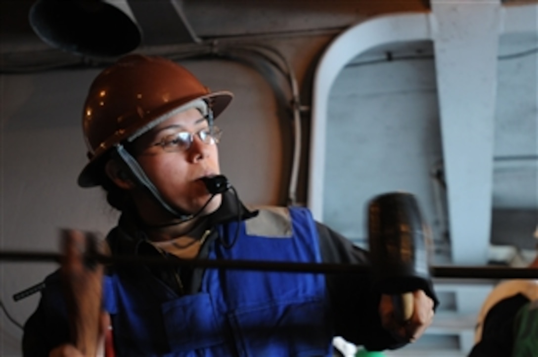 U.S. Navy Seaman Sarah Hernandez applies tension to a cable in fuel station 15 aboard the aircraft carrier USS Ronald Reagan (CVN 76) in the Pacific Ocean on March 21, 2009.  After the Reagan connected to guided-missile cruiser USS Chancellorsville (CG 62), wire-cable winches were used to hoist the fueling pump between the ships.  The Reagan is underway conducting sustainment exercises.  