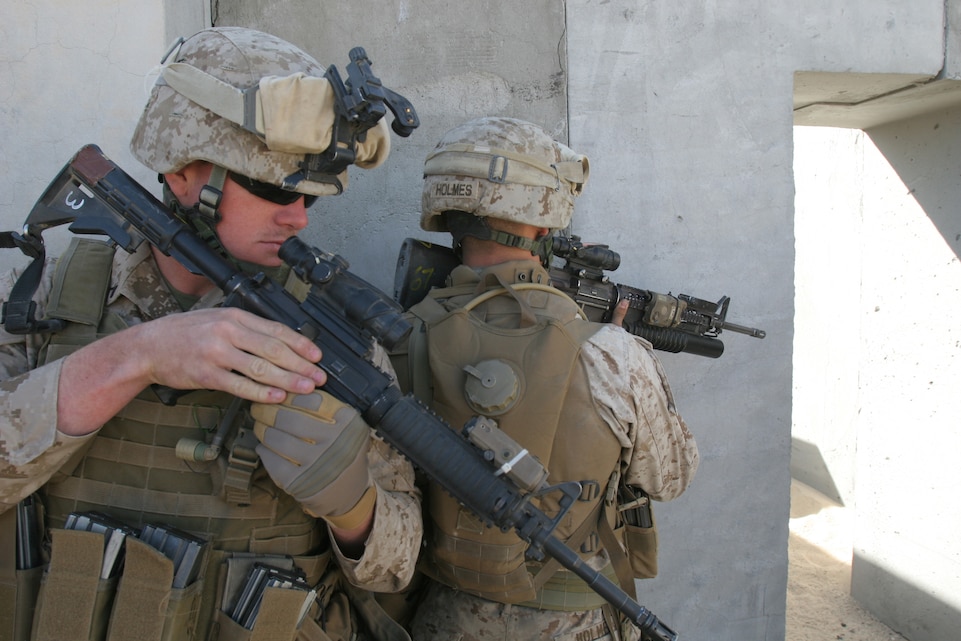 Pfc. John E. Hoban, 20, from Los Angeles, second in his team's stack, prepares to clear a building during a live fire grenade exercise here March 26. During the exercise Marines with Company E, Battalion Landing Team 2nd Battalion, 4th Marine Regiment, cleared half a building using hand grenades and the other half with rifle fire. This was the first time the Marines conducted this type of live fire exercise during their workups for their deployment with the 11th Marine Expeditionary Unit later this year. The live fire exercises were part of a month-long exercise the Marines are conducting away from Camp Pendleton, their home station.