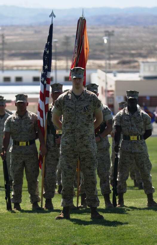 Lance Cpl. Brady Gustafson, a machine gunner with Golf Company, 2nd Battalion, 7th Marine Regiment, stands in from of the battalion at perfect parade rest, despite the amputation of his right leg below the knee. Gustafson received the Navy Cross and a meritorious promotion to corporal during a ceremony March 27 at Lance Cpl. Torrey Grey Field.