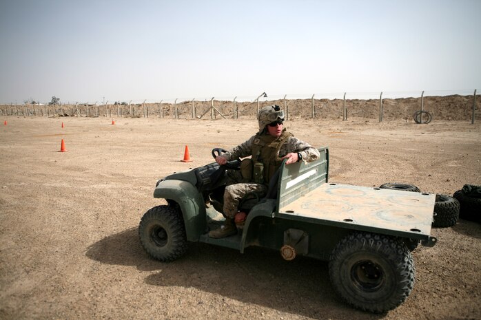 Cpl. Andrew L. Dekruiff, the personal effects officer, Camp Al Taqaddum Surgical Supply Section, practices reversing a multi-terrain vehicle at the Multi and All-terrain Vehicle Drivers’ Course at Camp Al Taqaddum, Iraq, March 27, 2009. The course allows students to obtain MTV/ATV licenses and also trains them to become instructors to provide MTV/ATV safety training and licenses to personnel in their units.  (U.S. Marine Corps photograph by Cpl. Bobbie A. Curtis)
