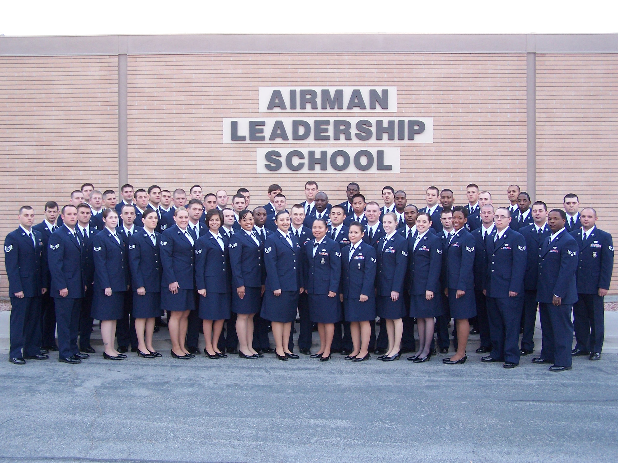 Airman Leadership School class 09-C pose for a picture in front of the ALS. .The following Airmen graduated Airman Leadership School from the officers club March 26. There were five distinguished graduates, one John Levitow Award winner, one academic award winner and one leadership award winner. 
