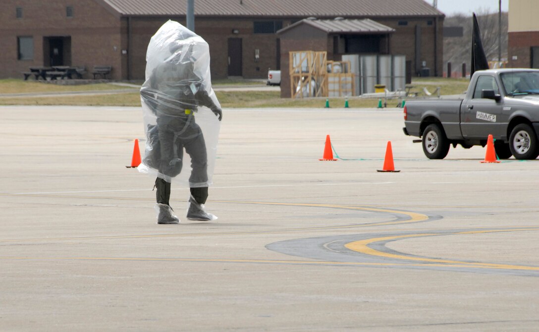 Covered in protective plastic while participating in a simulated chemical warfare exercise, a 303rd Fighter Squadron A-10 Thunderbolt II pilot leaves the flight line following a training mission during the 442nd Fighter Wing?s unit training assembly. The 442nd FW, an Air Force Reserve Command unit based at Whiteman Air Force Base, Mo., used the exercise to train its members to be able to continue to operate in all warfare environments. (US Air Force photo/Master Sgt. Bill Huntington)