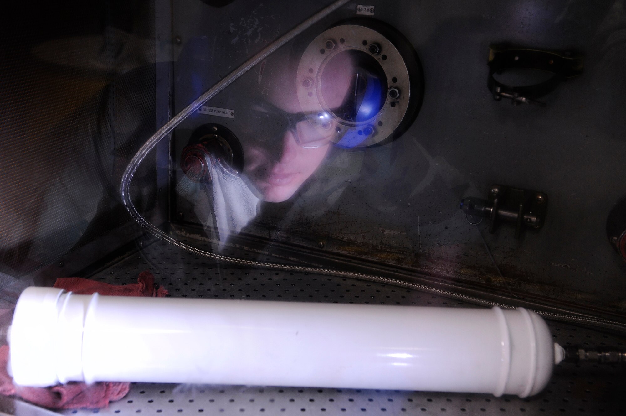 Staff Sgt. Jon-Michael Rull, 28th Maintenance Squadron hydraulics craftsman, observes a B-1B Lancer main landing gear emergency accumulator during a bench test, March 27. The testing is done behind a crash box to ensure maintain safety. (U.S. Air Force photo/Senior Airman Marc I. Lane)