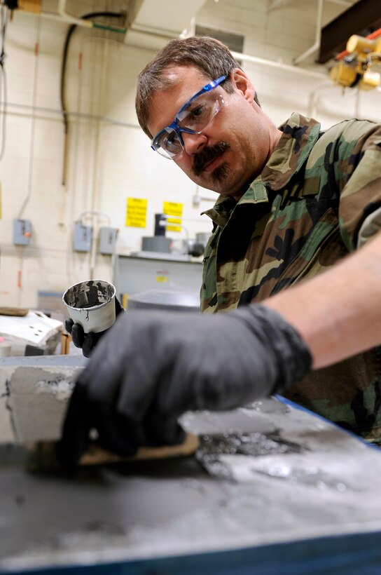 Shane Shaughnessy, 28th Maintenance Squadron structural technician, applies epoxy to a map case, March 27. The epoxy is used to bond a sheet of reinforcement metal to the map case. (U.S. Air Force photo/Senior Airman Marc I. Lane)