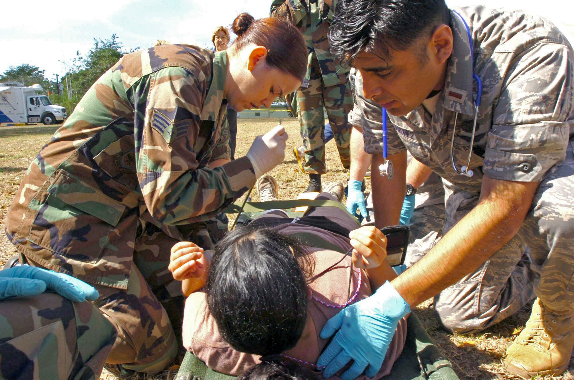 Senior Airman Kara Nicholas and 2nd Lt. Tomas Chavez check the vital signs of an incoming patient during Exercise Vigilant Guard March 25 in Camp Santiago, Puerto Rico. Airman Nicholas is a medic, and Lieutenant Chavez is a flight surgeon candidate. Both are from the 161st Air Refueling Wing from the Arizona National Guard. (U.S. Army photo/Staff Sgt. S. Patrick McCollum) 
