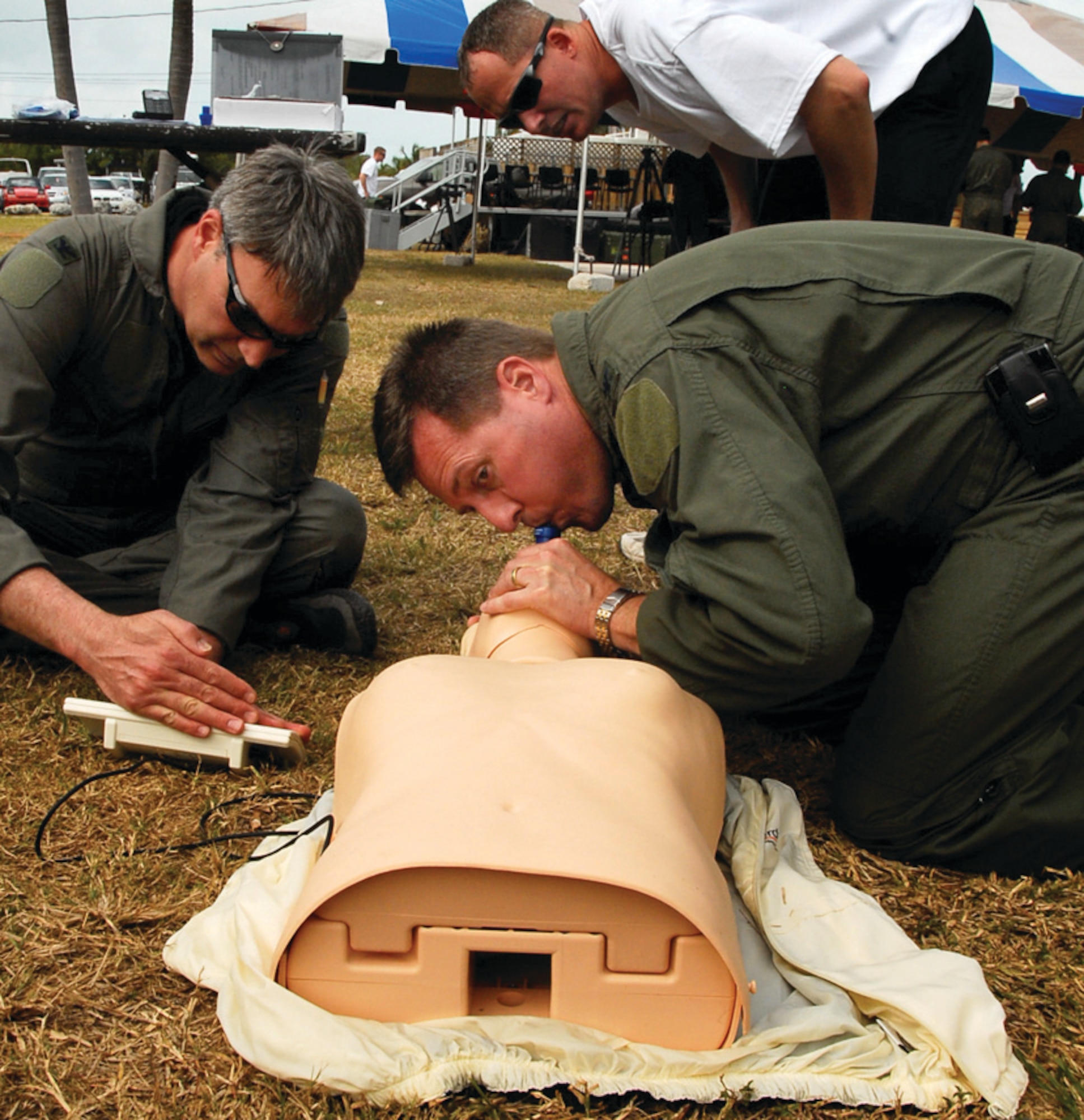 Colonel Gary L. Akins, 201 AS commander, performs rescue breathing on a CPR dummy, while Col. Kurt Vogel, National Guard Bureau AF/A8 advisor, looks at the monitor to ensure Colonel Akins is giving the correct amount of breath. (U.S. Air Force photo/ Tech. Sgt. Adrianne Wilson)