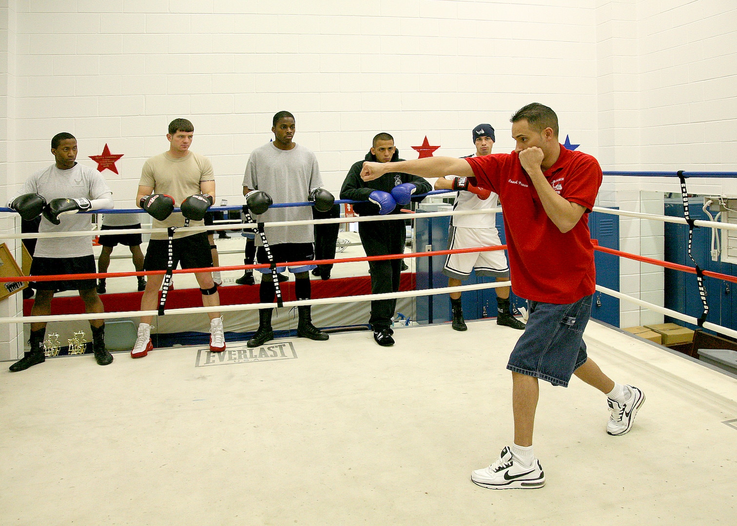 3/24/2009 - Air Force boxing coach Steven Franco demonstrates a proper striking technique in front of 11 Air Force boxing camp members at the Bennett Fitness Center. (USAF photo by Robbin Cresswell) 