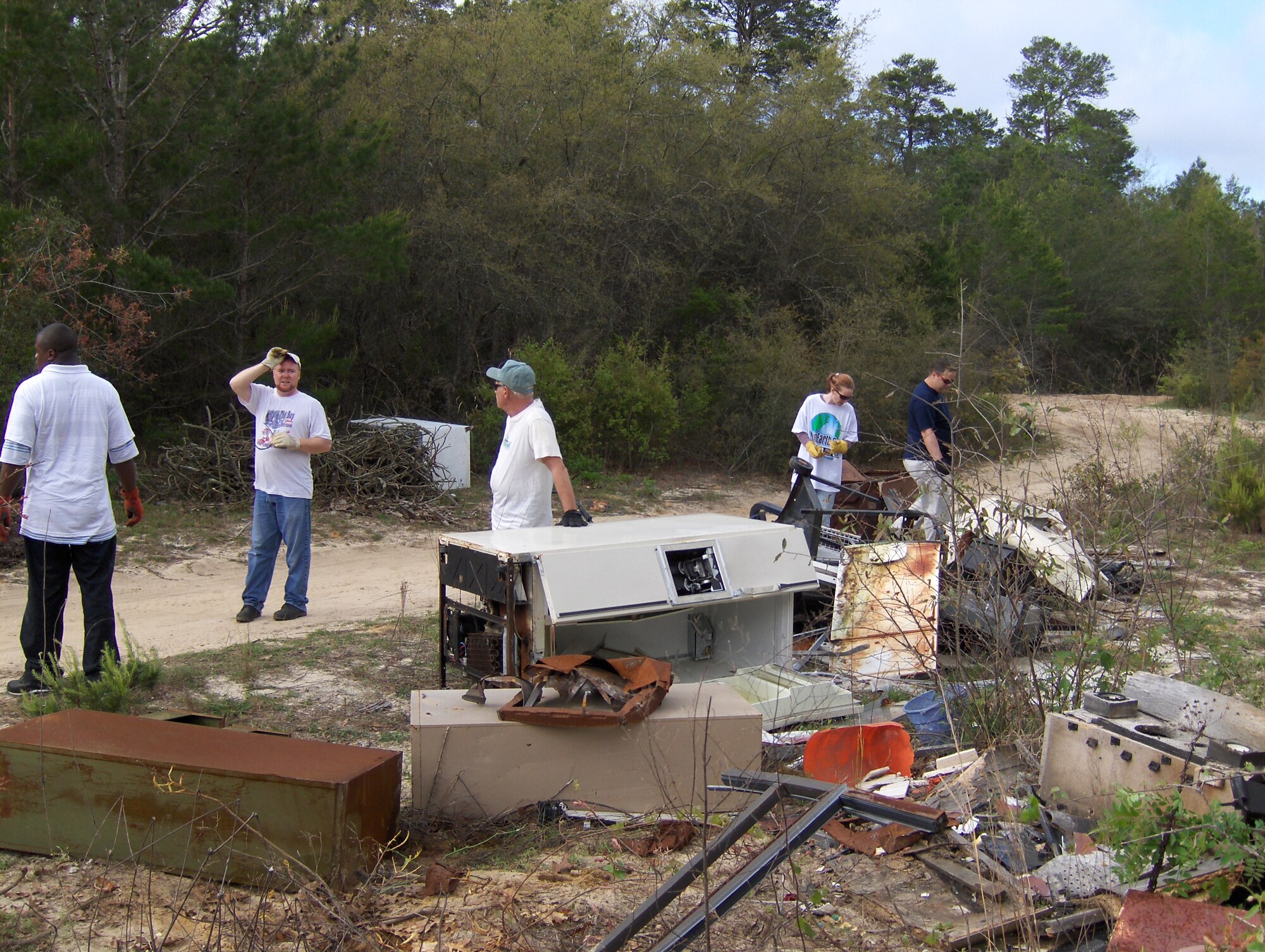 Volunteers haul appliances from Eglin reservation during Earth Day cleanup activities last year. More than 12 tons of illegally dumped debris was removed from Eglin reservation during the cleanup. Earth Day activities will occur throughout the week of April 16-23. Photo by Jerron Barnett.