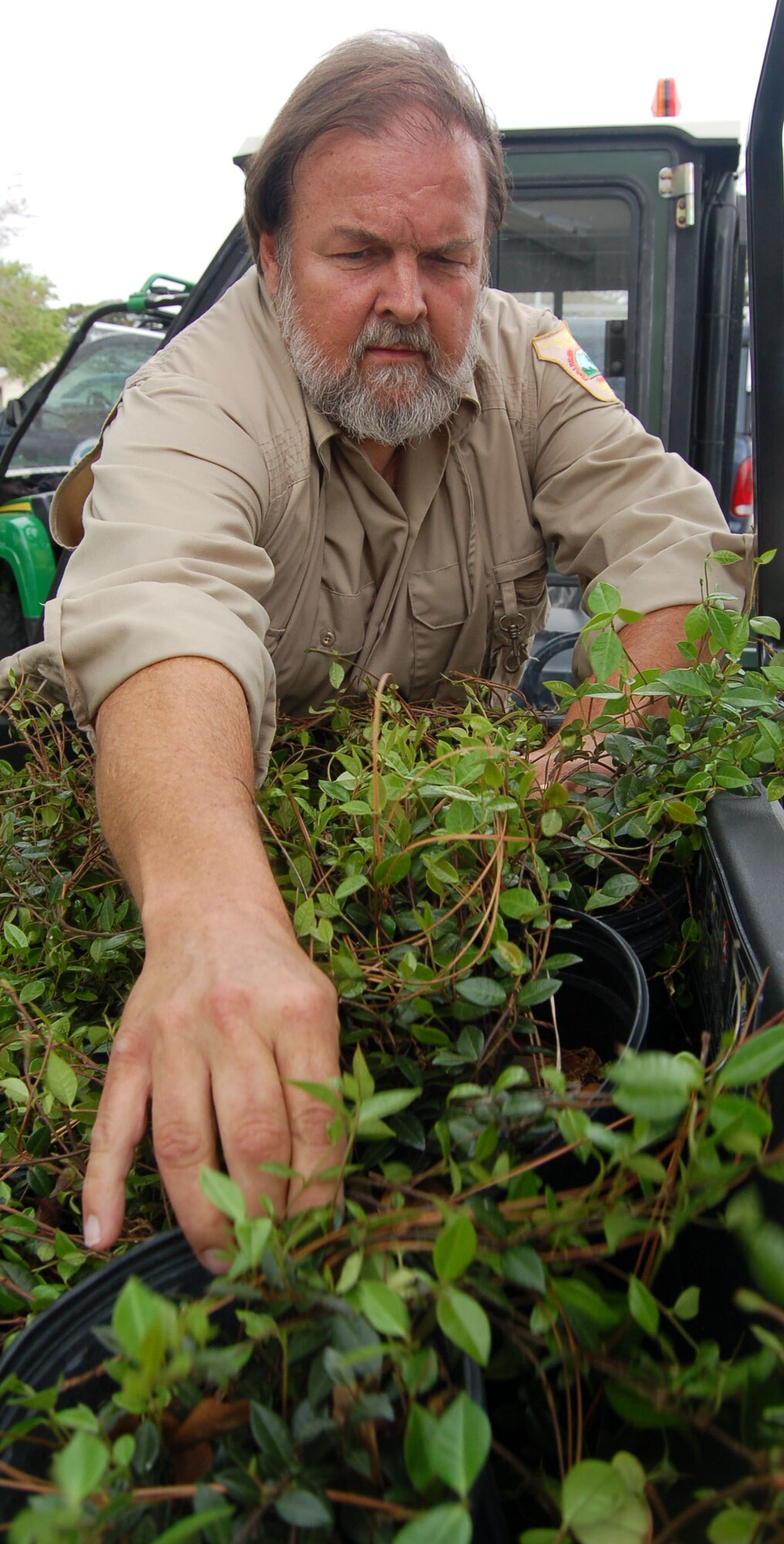 Dennis Teague, Eglin Natural Resources endangered species biologist, gathers native Jasmine to plant around Bldg. 670 as part of Earth Day activities last year. Native plants require less water, fertilizer, pesticides and maintenance than non-native species. Earth Day activities will occur throughout the week of April 16-23. Photo by Jerron Barnett.