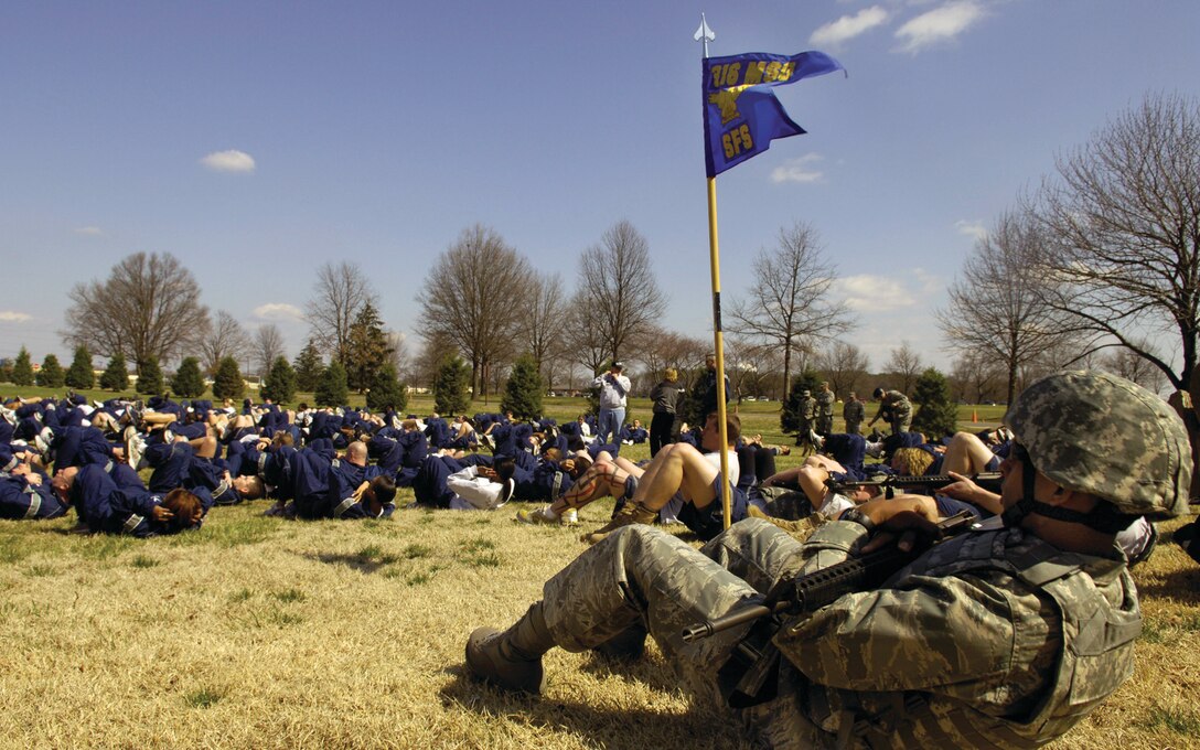 First Lt. Patrick G. Fruge, 316th Security Forces Squadron officer in charge of Logistics and Readiness, performs sit-ups prior to running the monthly 316th Wing run March 20. Guests from the 89th Airlift Wing, 113th Wing and other units participated in the 1.7 mile running formation, enhancing base unity and espirit de corps. (U.S. Air Force photo/ Senior Airman Renae Kleckner)