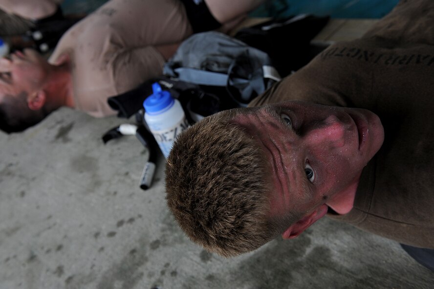 MOODY AIR FORCE BASE, Ga. -- A candidate from class 09A who is enrolled in the combat rescue officer selection course looks over at an instructor while performing leg exercises at the pool here March 23. The candidates were required to perform numerous physical and mental exercises during the six day course. (U.S. Air Force photo by Senior Airman Gina Chiaverotti) 