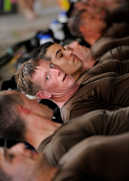 MOODY AIR FORCE BASE, Ga. -- Candidates from class 09A who are enrolled in the combat rescue officer selection course perform flutter kicks on the edge of a pool during a combat rescue officer school here March 24. The candidates must pass a six day course that includes both mental and physical examinations to even be considered for a position as a combat rescue officer. (U.S. Air Force photo by Senior Airman Brittany Barker) 