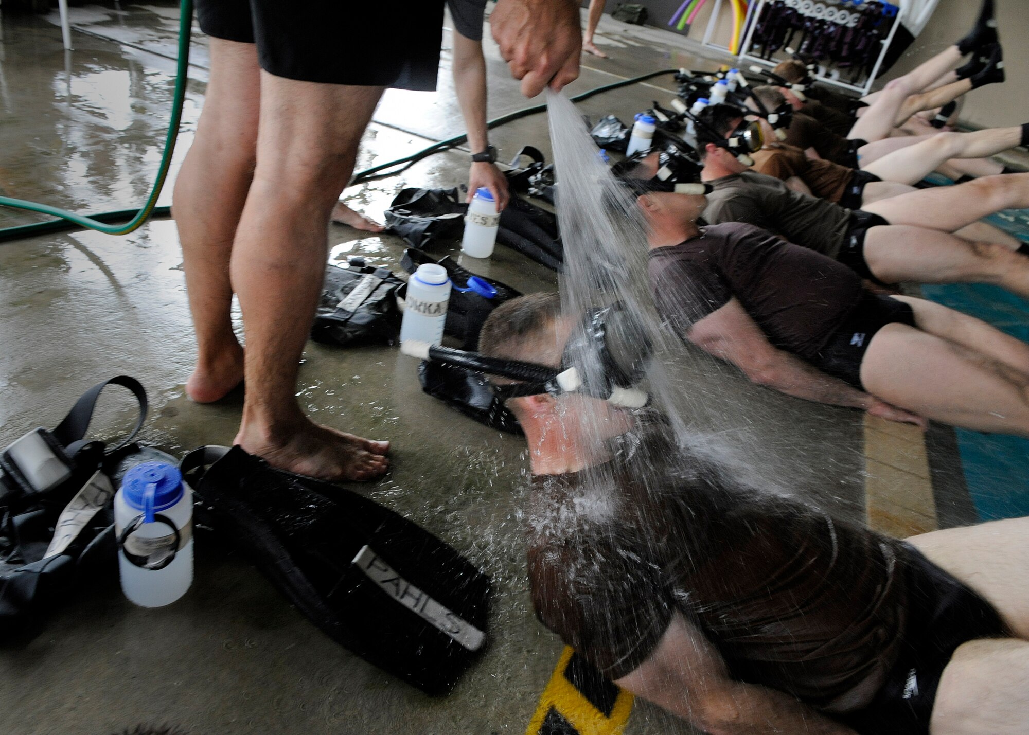 MOODY AIR FORCE BASE, Ga. -- Candidates from class 09A who are enrolled in the Combat Rescue Officer school perform flutter kicks on the edge of the base pool here March 24. The candidates must pass a six day course that includes both mental and physical examinations to even be considered for a position as a combat rescue officer. (U.S. Air Force photo by Senior Airman Brittany Barker)