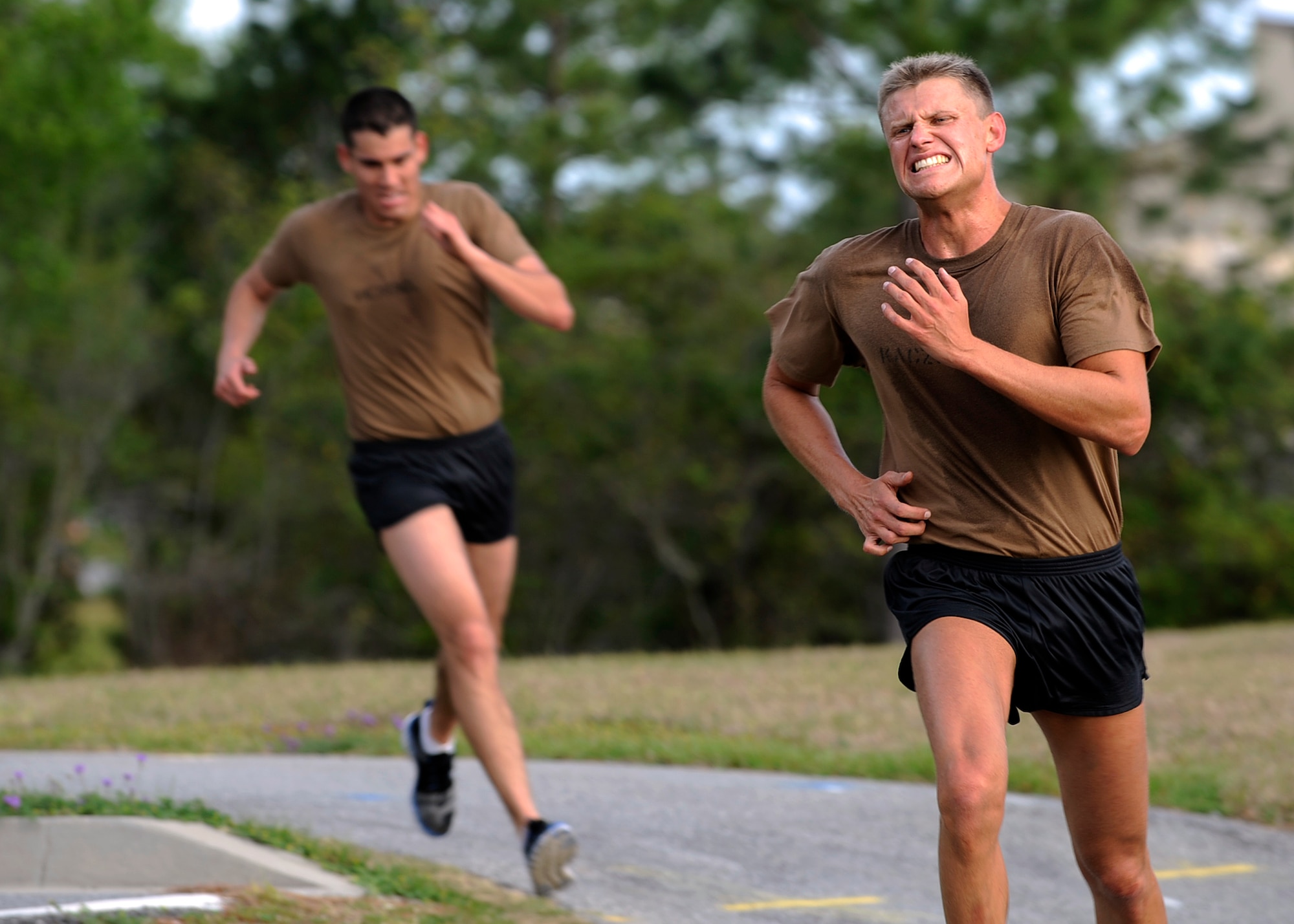 MOODY AIR FORCE BASE, Ga. -- Two candidates from class 09A who are enrolled in the Combat Rescue Officer School sprint to the finish line during an eight mile run here March 24. The candidates must pass a six day course that includes both mental and physical examinations to even be considered for a position as a combat rescue officer. (U.S. Air Force photo by Senior Airman Brittany Barker)