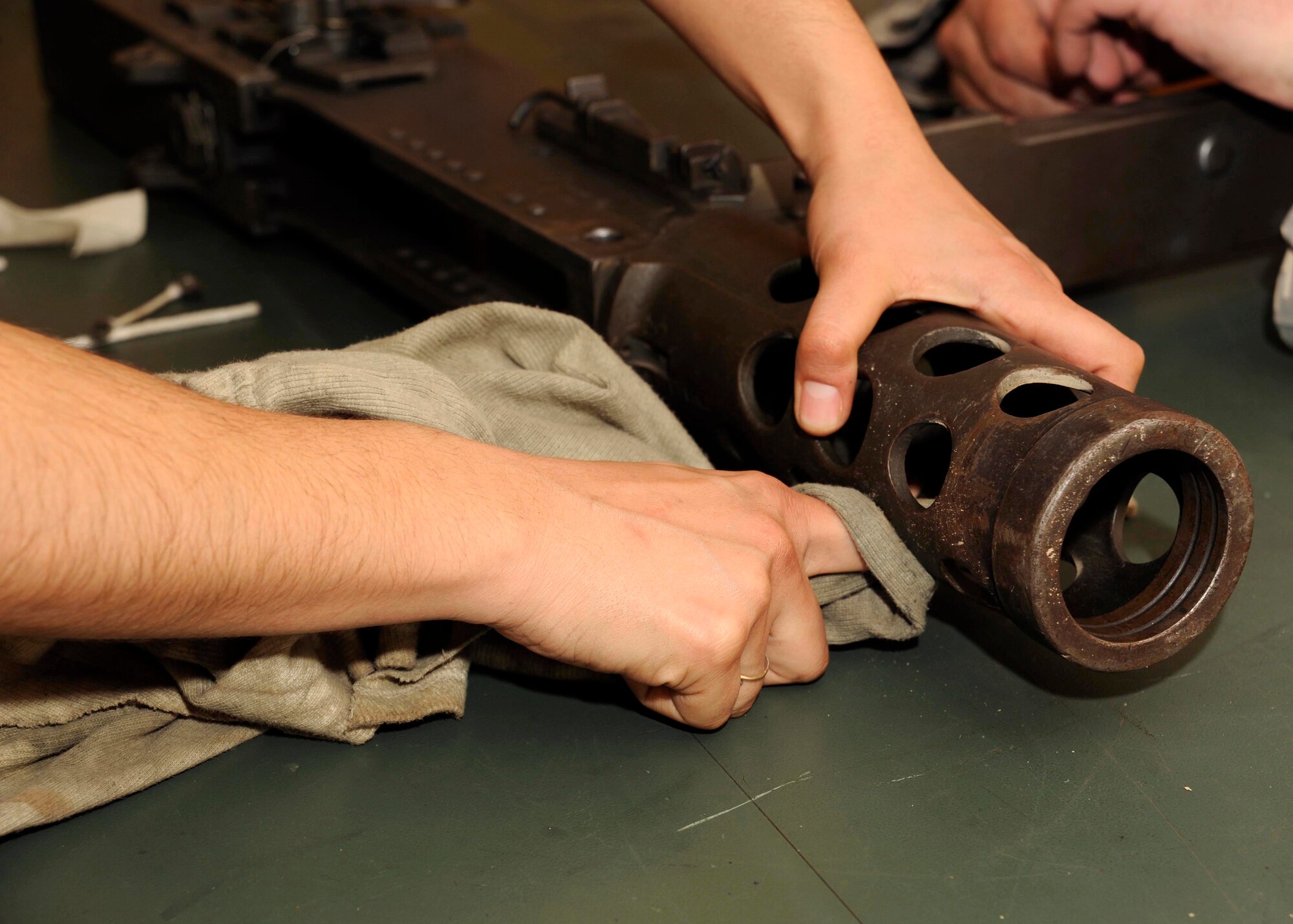Senior Airman Elizabeth Gonzalez cleans the .50 caliber machine gun at the armory at Sather Air Base, Iraq, March 12. Airman Gonzalez is one of only a few security forces members qualified on the .50 cal here. Airman Gonzales is a 447th Expeditionary Security Forces Squadron heavy weapons operator. (U.S. Air Force photo/Senior Airman Jacqueline Romero)