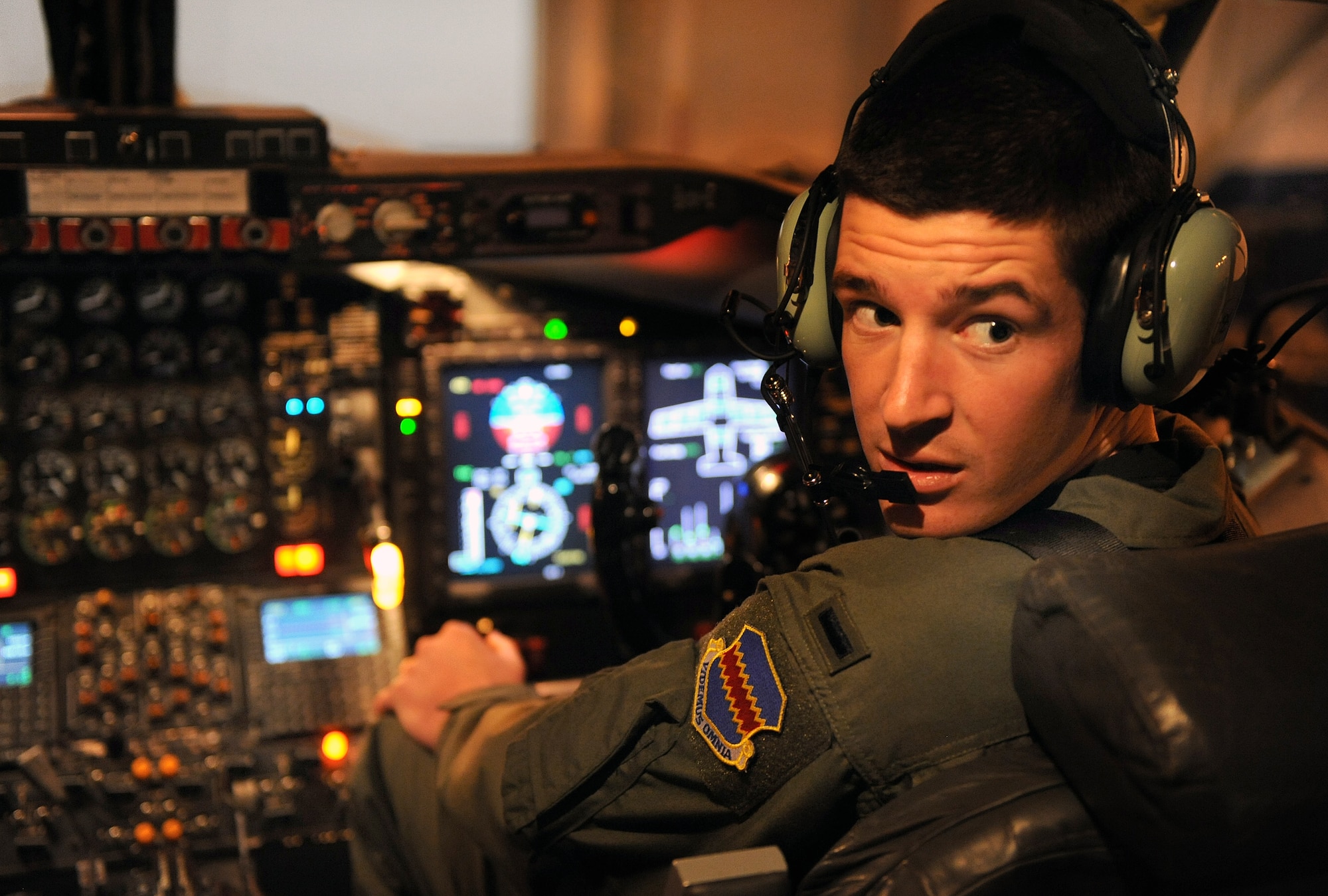 OFFUTT AIR FORCE BASE, Neb.-- 1st Lt. William Schoen, pilot with the 338th Combat Training Squadron, trains to manually lower the landing gears on a RC-135/Rivet Joint aircraft parked inside Dock 2 of the Bennie Davis Maintenance Facility, March 25.  This training is crucial for aircrew members to master if the landing gear fail to electronically lower.

 U.S. Air Force Photo by Josh Plueger  
