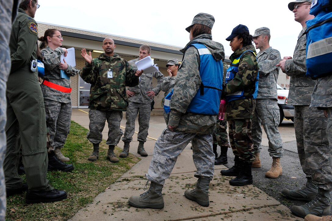 LANGLEY AIR FORCE BASE, Va. -- Airmen gather to review the overall result of the All Hazards Response Training Exercise here on March 26.  The exercise tested the ability to provide medical care to mass casualties during a simulated chemical attack.  (U.S. Air Force photo/Senior Airman Vernon Young)
