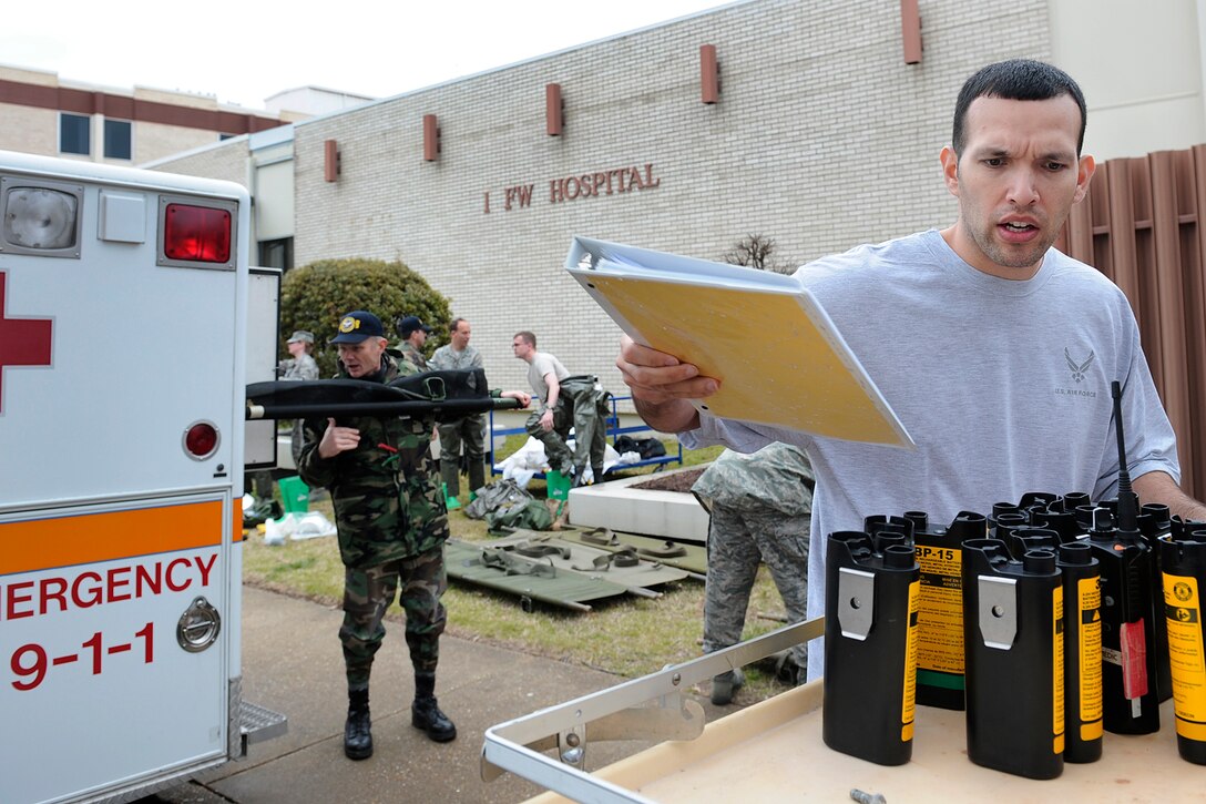 LANGLEY AIR FORCE BASE, Va. -- Staff Sgt. Carlos Claudio, 1st Medical Surgical Operations Squadron medical technician, cleans an area outside of the emergency room after an All Hazards Response Training Exercise here on March 26.  The exercise tested the ability to provide medical care to mass casualties during a simulated chemical attack.  (U.S. Air Force photo/Senior Airman Vernon Young)
