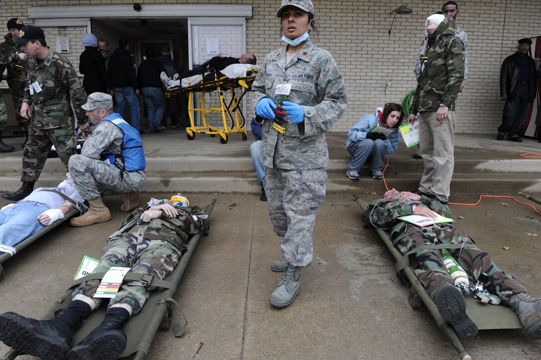 LANGLEY AIR FORCE BASE, Va. -- Airmen from the 1st Medical Group prepare wounded patients outside of the emergency room to be treated during and All Hazards Response Training Exercise here on March 26.  Airmen participating in the exercise were tested on the ability to respond to a chemical attack resulting in mass casualties.  (U.S. Air Force photo/Senior Airman Vernon Young)
