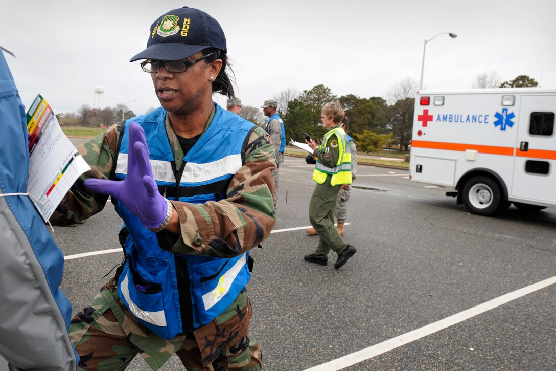 LANGLEY AIR FORCE BASE, Va. -- Maj. Clynise Simpson, 1st Aerospace Medicine flight medicine chief, checks wounds to ensure proper care is performed on patients during an All Hazards Response Training Exercise here March 26.  Airmen participating in the exercise were tested on the ability to respond to a chemical attack resulting in mass casualties.  (U.S. Air Force photo/Senior Airman Vernon Young)
