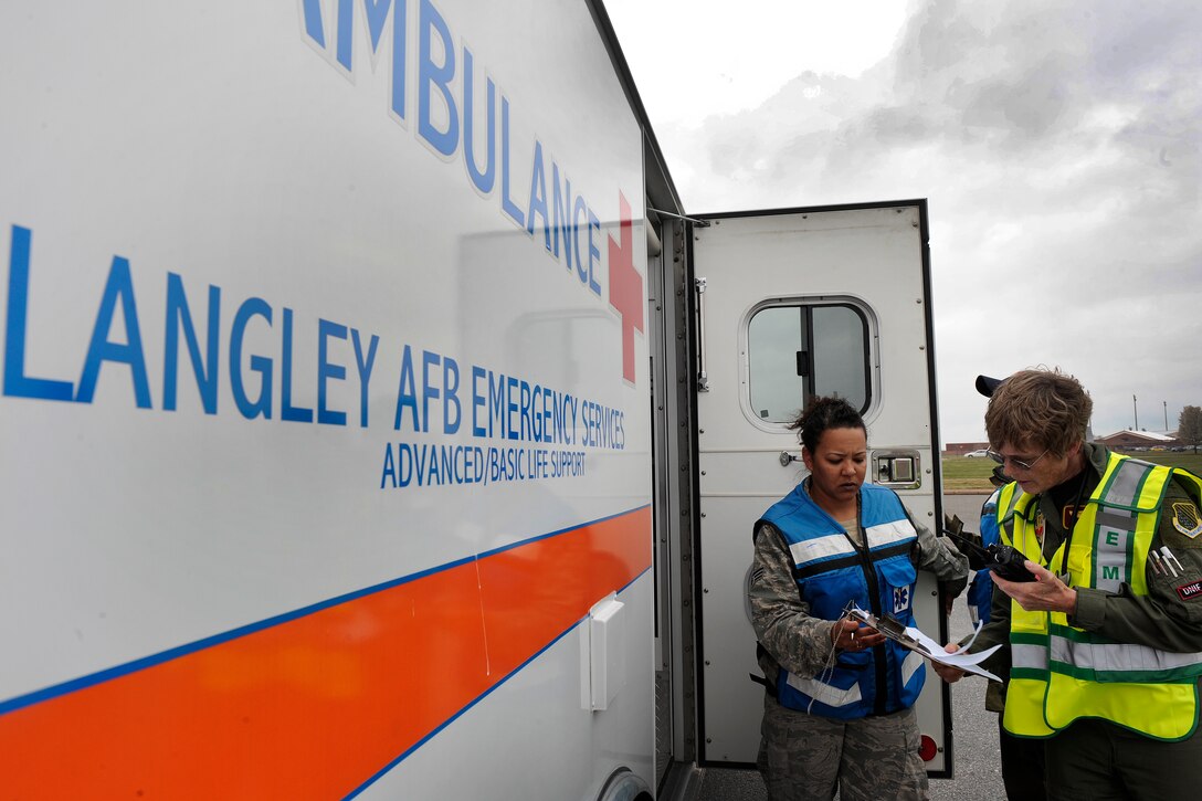 LANGLEY AIR FORCE BASE, Va. -- Col. Diane Huey and Senior Airman Catrina Shultz, 1st Aerospace Medicine Squadron, check paperwork concerning mass casualties during an All Hazards Response Training Exercise here on March 26.  Airmen participating in the exercise were tested on the ability to respond to a chemical attack resulting in mass casualties.  (U.S. Air Force photo/Senior Airman Vernon Young)