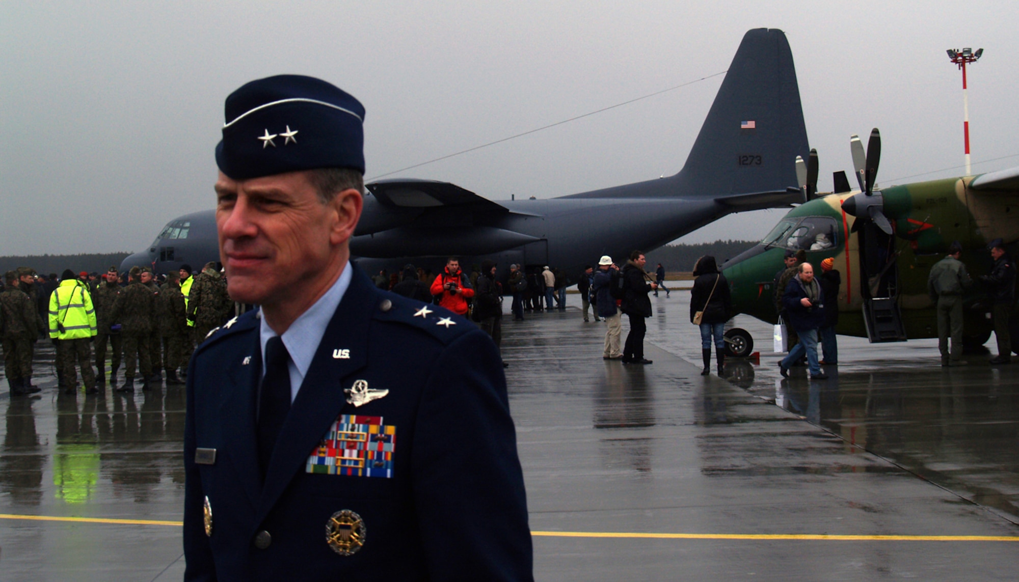 Air Force Maj. Gen. William Chambers, United States Air Forces in Europe director of air and space operations, returns from viewing the first of five refurbished C-130E Hercules military transport planes and spare parts delivered Tuesday to the Polish Air Force at Powidz Air Base. The general said the C-130 is a great symbol of the American-Polish partnership, and we’re grateful to be alongside them. The entire project, including total refurbishment of five aircraft, support equipment, supplies, training and contracted logistics support, is valued at $120 million. The donation is a result of an American pledge to provide Poland with such a capability, and is fully funded through bilateral military assistance grant money.  (Air Force photo by Capt. Tony Wickman)