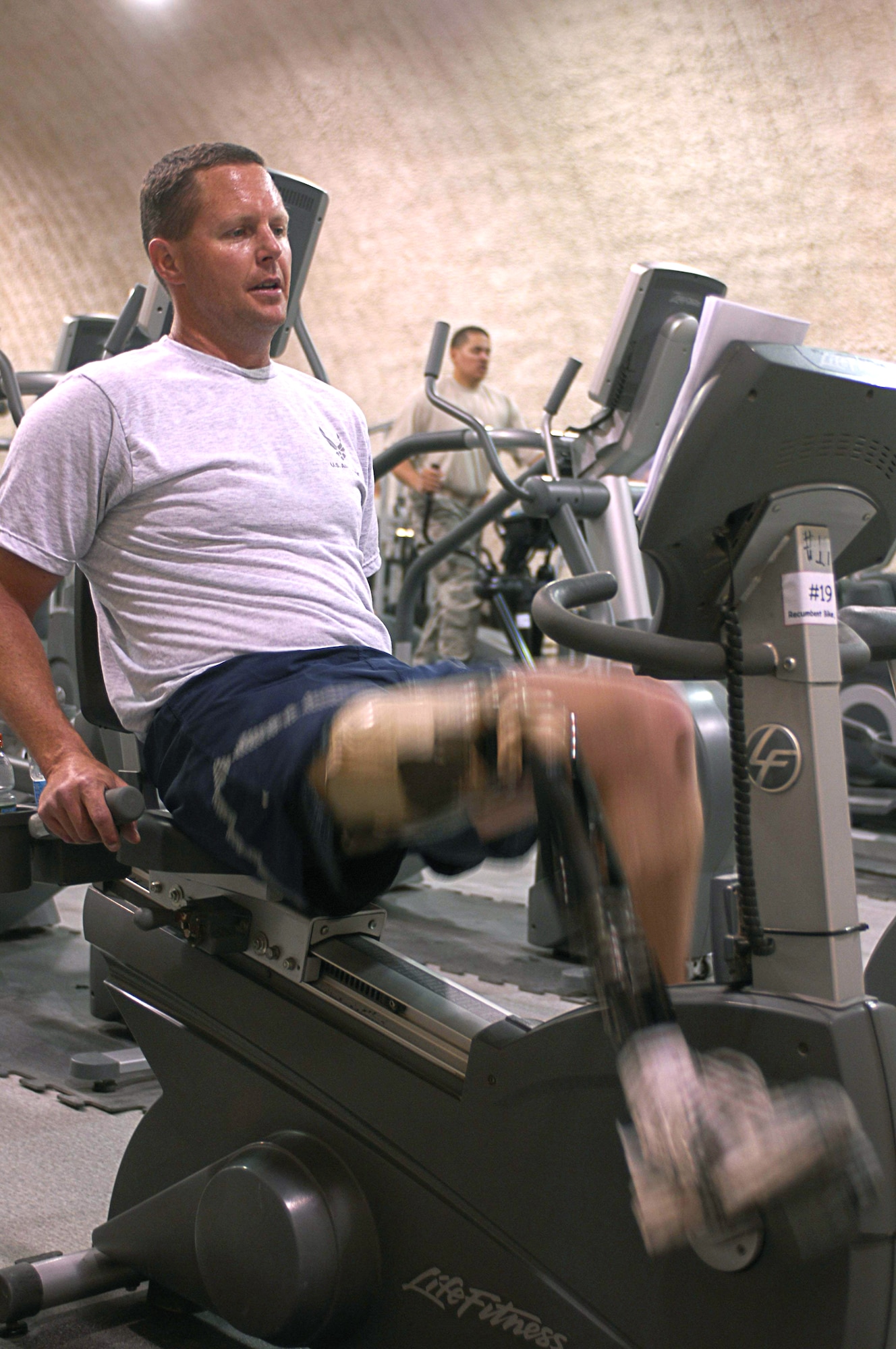 Major Alan Brown rides a stationary bicycle March 21 at Bagram Airfield, Afghanistan. Major Brown is an amputee C-130 Hercules pilot deployed with the 774th Expeditionary Airlift Squadron from the 187th Airlift Squadron of the Wyoming Air National Guard. He lost his leg in a hunting accident 10 years ago, and after seven years he regained his qualifcations to fly. Major Brown works out daily riding the stationary bike using a custom strap developed by the unit's life support crew. (U.S. Air Force photo/Senior Airman Erik Cardenas) 
