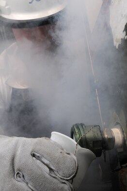 Airman 1st Class Matt Fitch, 100th Logistics Readiness Squadron Petroleum, Oils, and Lubricants apprentice, takes a sample of liquid oxygen “LOX” to test for serviceability March 26, 2009, at RAF Mildenhall, England. The Amarillo, Texas, native wears protective clothing to cover all exposed areas from the -297 degrees Fahrenheit boiling temperature of LOX. Liquid oxygen is pure oxygen in a liquid form and has an expansion ratio of 860:1. This offers aviators and aircrew a longer duration of breathable oxygen without the size and weight of conventional methods. (U.S. Air Force photo by Staff Sgt. Jerry Fleshman)
