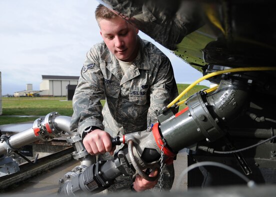 Airman 1st Class Matt Fitch, 100th Logistics Readiness Squadron Petroleum, Oils, and Lubricants apprentice, attaches a fuel nozzle to fill an aircraft refuel truck March 26, 2009, at RAF Mildenhall, England. Airman Fitch supplies the fuel trucks so they are able to provide a constant supply of fuel for awaiting aircraft. (U.S. Air Force photo by Staff Sgt. Jerry Fleshman)
