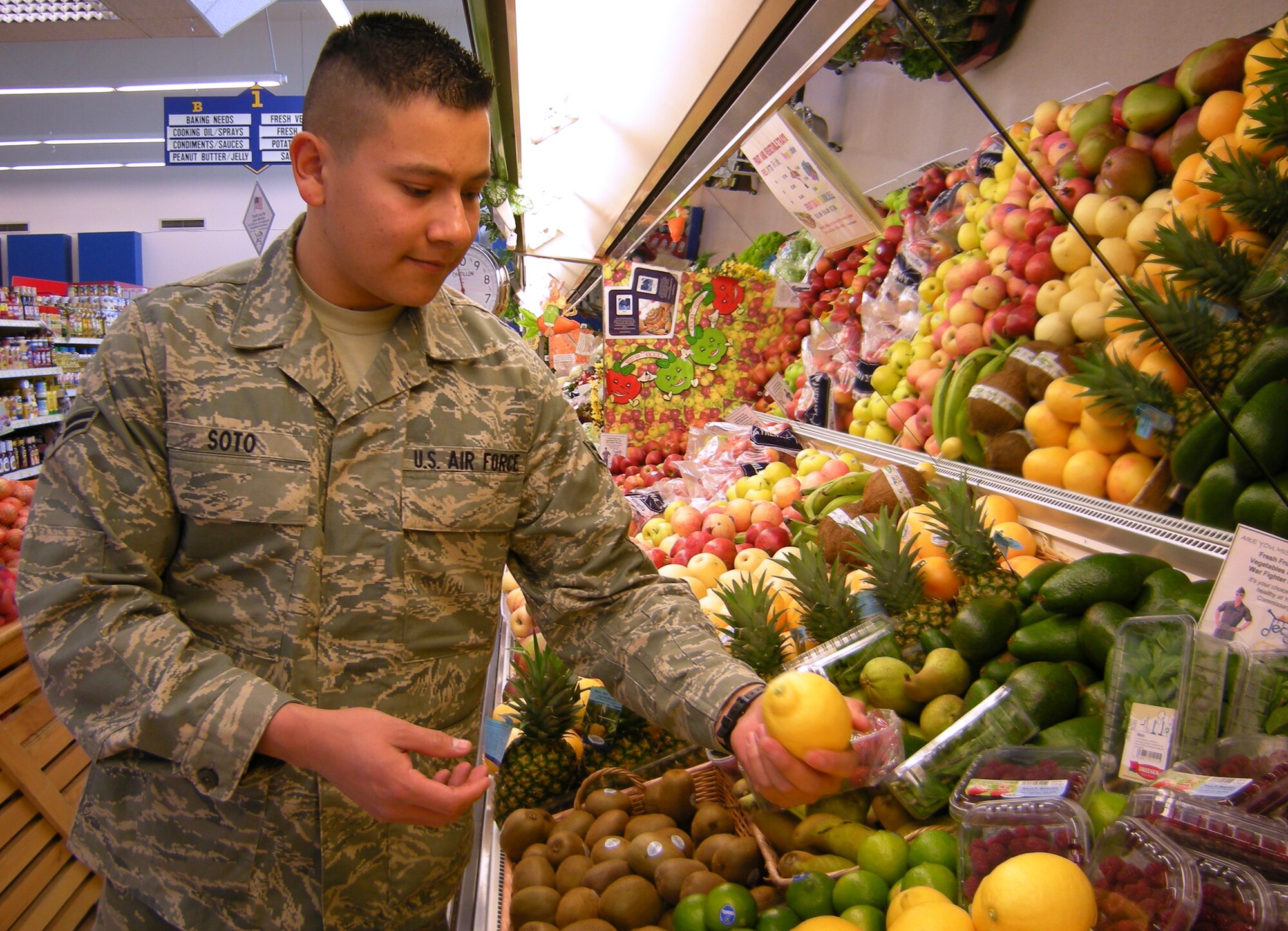 SPANGDHALEM AIR BASE, Germany – Airman 1st Class Luis Soto, 52nd Equipment Maintenance Squadron, checks a lemon for ripeness at the Spangdahlem Commissary. Lemon can be used as a low-calorie flavoring for fish and vegetables. It can also be used instead of high fat dressings to season salads. (U.S. Air Force photo by Staff Sgt. Tammie Moore) 