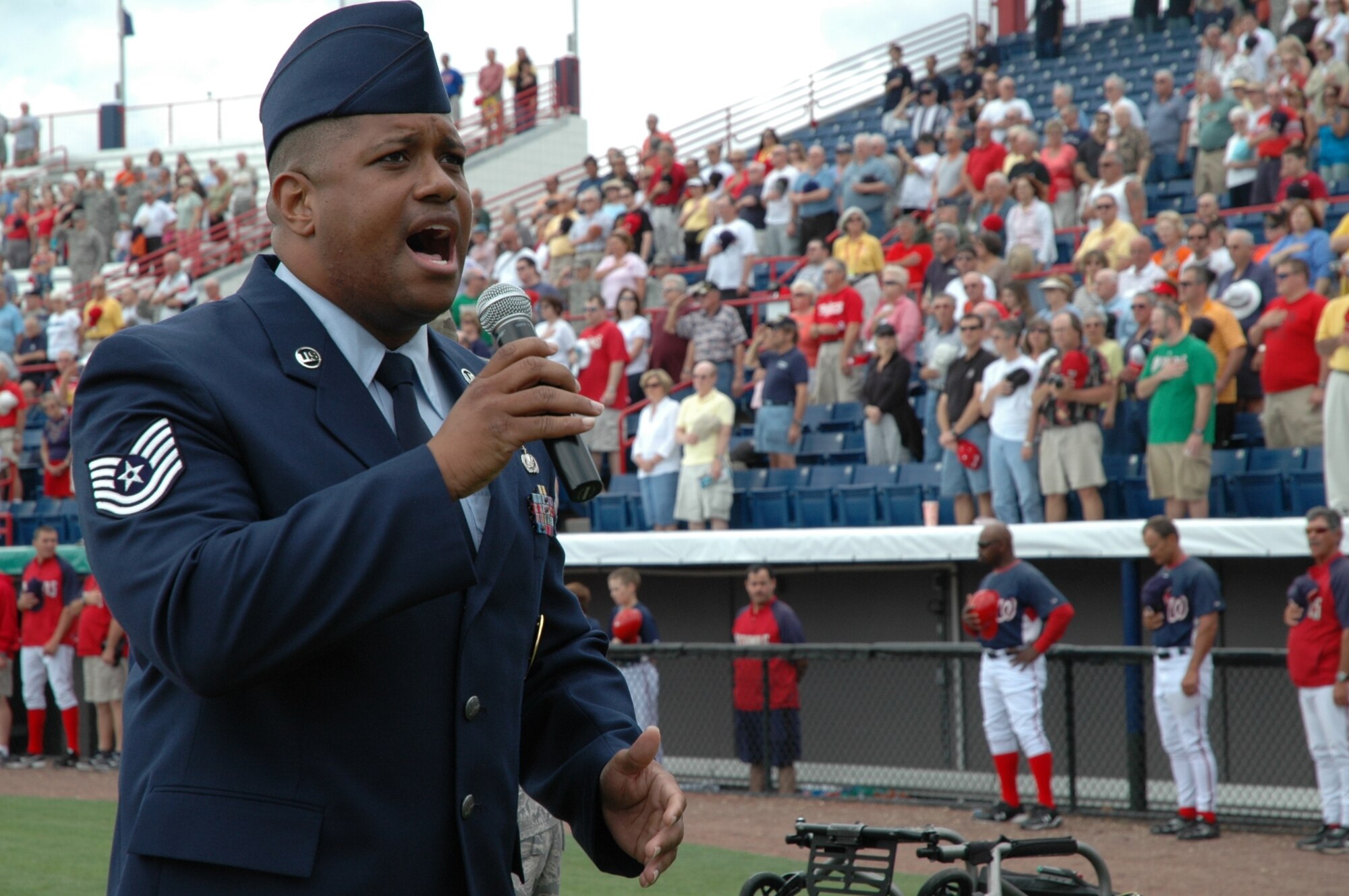 Tech. Sgt. Antonio McCloud of the 333rd Recruiting Squadron sings the National Anthem to begin Military Appreciation Day at the Space Coast Stadium March 19. Members from several miltary units came to view a free baseball game and took part in the opening ceremonies. (U.S. Air Force photo by Chris Calkins)