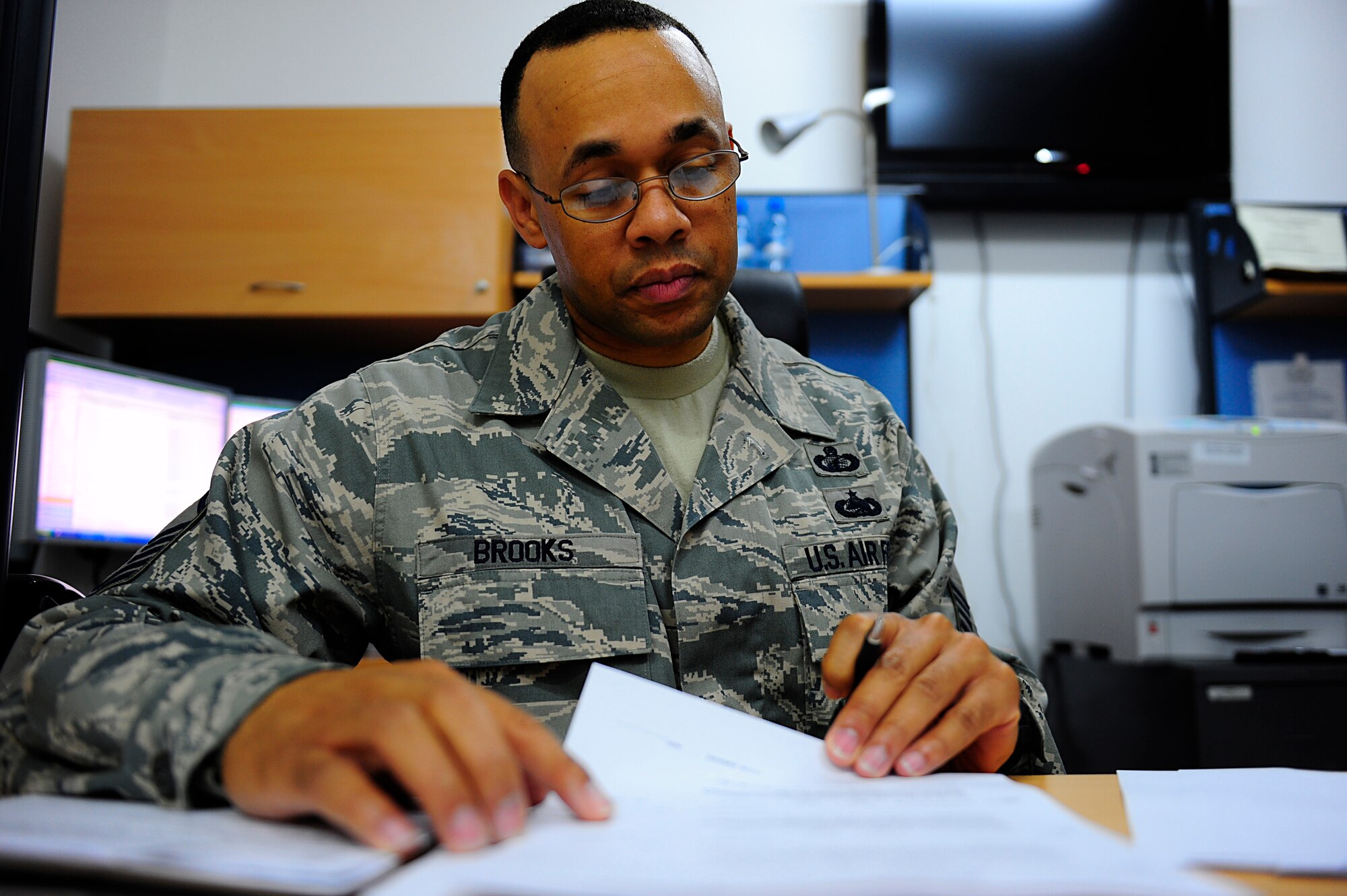 SOUTHWEST ASIA - Master Sgt. Tommy Brooks Jr., 380th Expeditionary Contracting Squadron reviews a contract for hood and duct cleaning services for both dining facilities, Mar 27. Sergeant Brooks is responsible for managing 46 mission critical service contracts for the 380th AEW including ground fuel, food services, sewage, refuse and medical services. Sergeant Brooks is deployed from the 1st Contracting Squadron, Langley AFB, Va. and hails from Ocala, Fla. (U.S. Air Force photo by Senior Airman Brian J. Ellis) (Released)