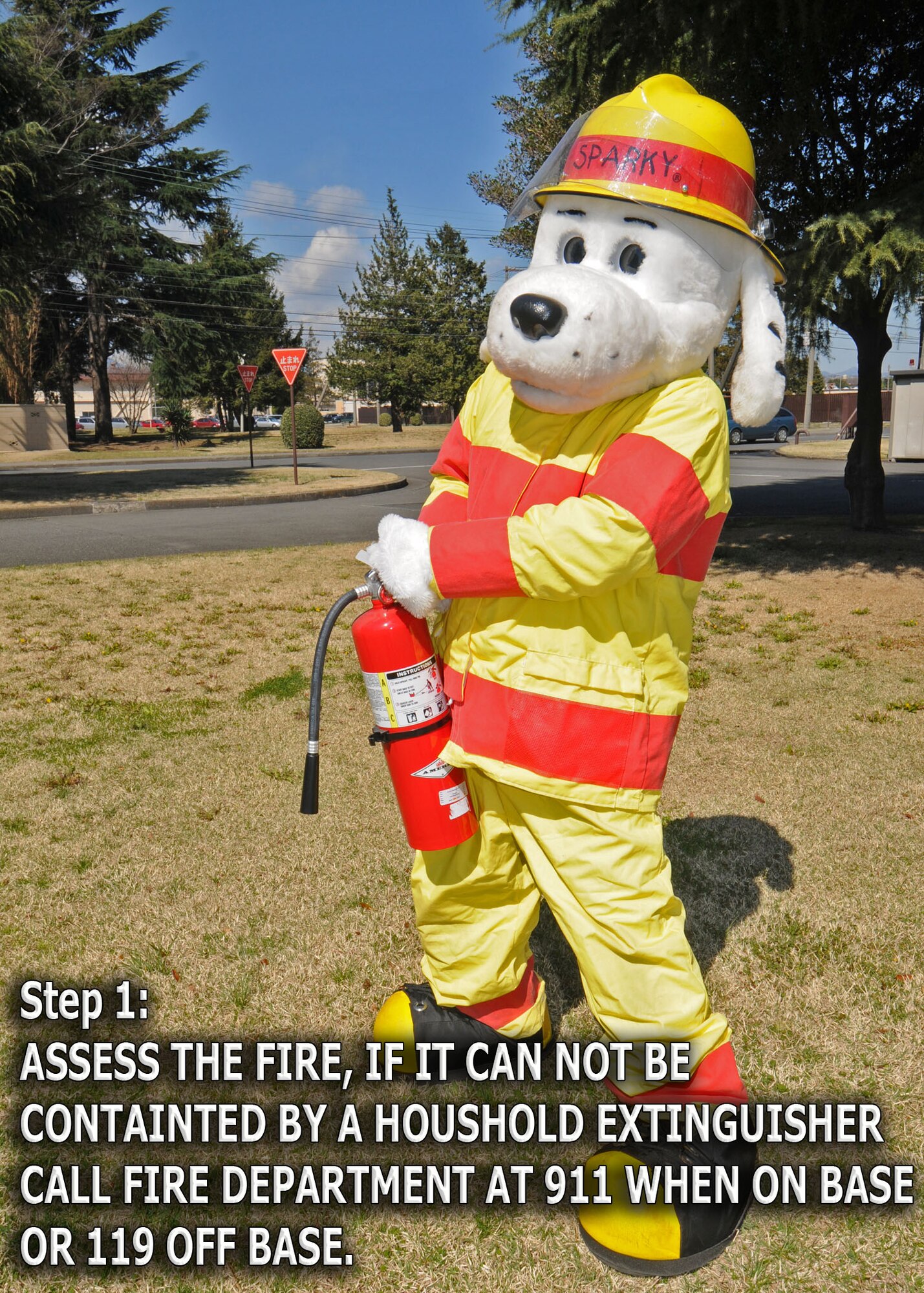 YOKOTA AIR BASE, Japan -- Sparky the Fire Dog demonstrates how to properly engage a fire extinguisher. The 374th Civil Engineer Squadron fire department is promoting spring fire prevention week April 13 through 17. (U.S. Air Force illustration/ Senior Airman Veronica Pierce)