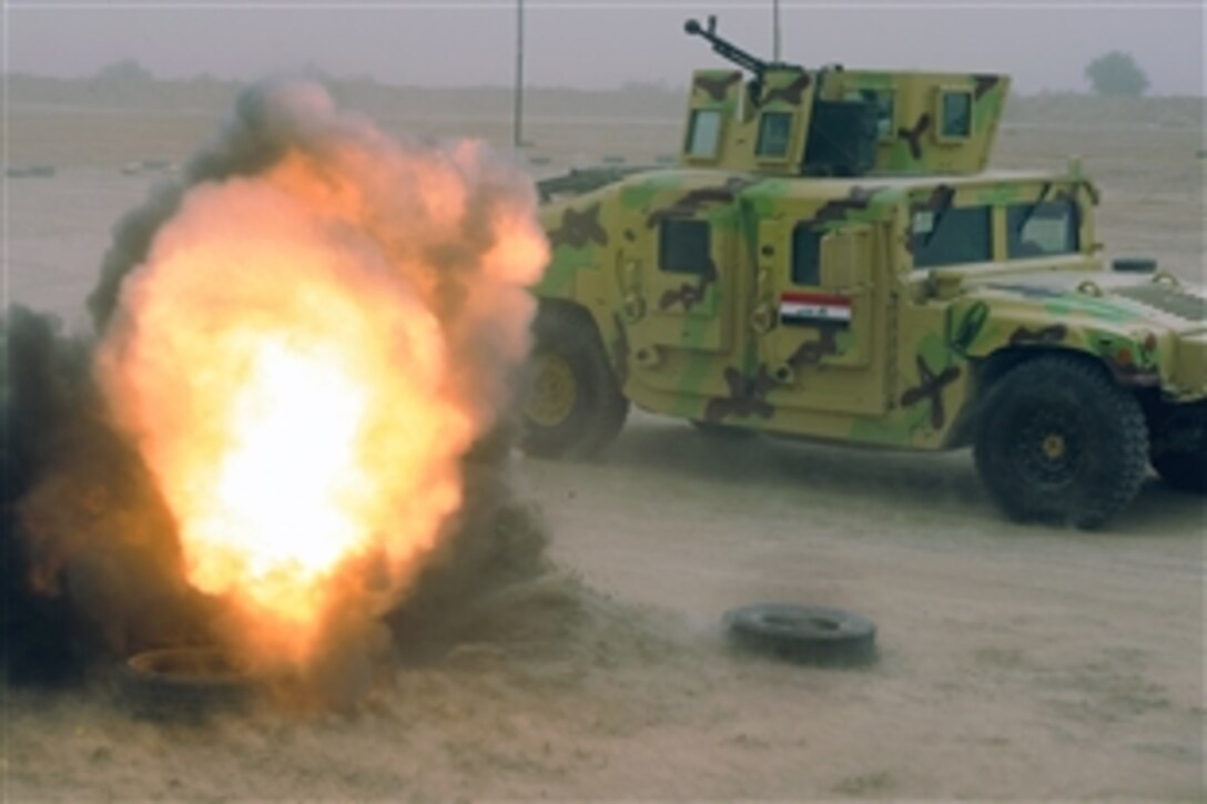 A small training charge is detonates as Iraqi army soldiers drive through the Improvised Explosive Device lane during reaction training to IED drills on Camp Diwaniyah, Iraq, March 24, 2009. U.S. Forces on Camp Diwaniyah over saw the training and assisted the Iraqi soldiers with their training. The small explosive is used to provide realism in the soldier's training. 