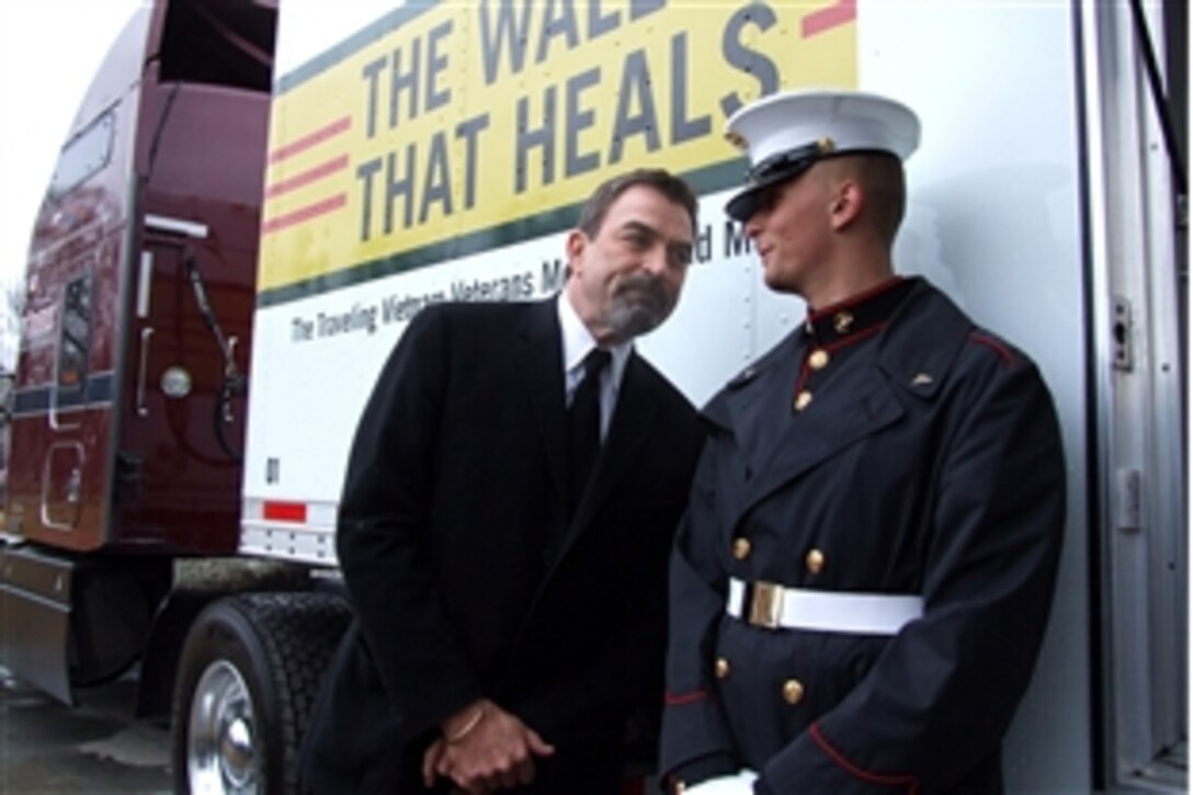 Actor Tom Selleck, spokesman for the Vietnam Veterans Memorial Fund's Education Center at the Vietnam Wall project, talks to Marine Lance Cpl. Joshua Michael, 8th and I Marine Barracks, during a ceremony on the National Mall, March 26, 2009. 