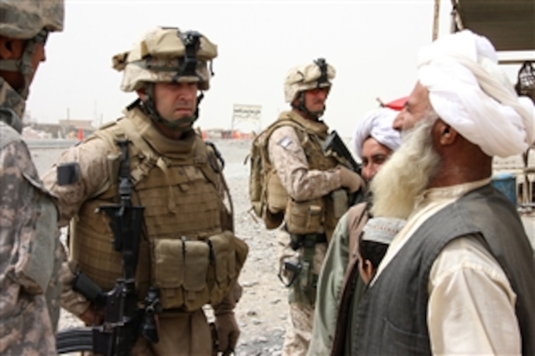 U.S. Marine Corps Lt. Col. David L. Odom talks to Afghans in Delaram, Farah, Afghanistan, March 23, 2009. Delaram citizens have been the victims of two recent insurgent suicide attacks and a plot to harm civilians by planting an improvised explosive device near the bazaar. Odom is commanding officer of 3rd Battalion, 8th Marine Regiment, and the ground combat element for the Special Purpose Marine Air Ground Task Force-Afghanistan. 