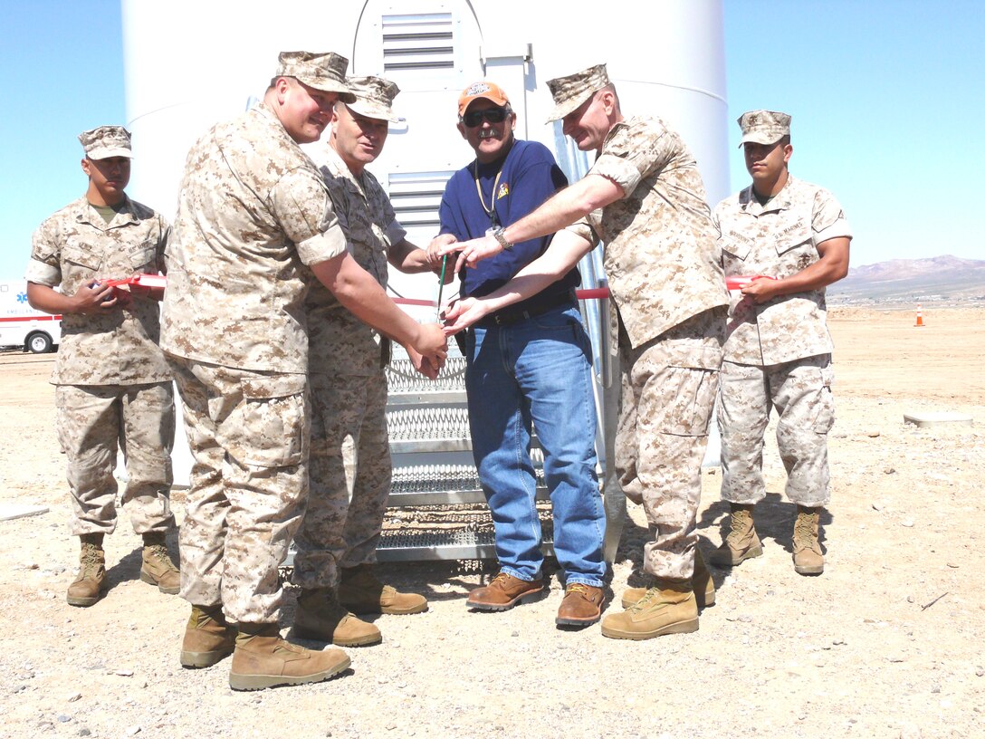 (Foreground, left to right) Navy Lt. Aaron Chetelat, Regional Officer in Charge of Construction, Marine Corps Logistics Base Barstow, Calif., Maj. Gen. Michael R. Lehnert, comanding general, Marine Corps Installations West, Randy Miner, project manager, Brownco Construction, based in Riverside, Calif., and Col. Kenneth D. Enzor, commanding officer, MCLB Barstow, cut the ribbon to commission the first wind turbine aboard any Marine Corps installation, March 27, 2009