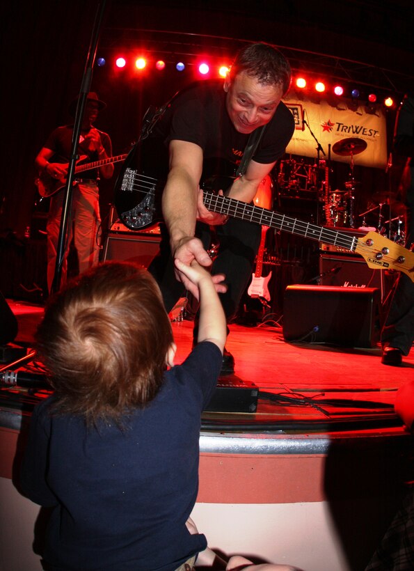 Gary Sinise, the co-star of the six-time Oscar winning movie Forrest Gump, and bass guitar player for the Lt. Dan Band, reaches out to one of his newest fans during their show March 28 night at the Sunset Cinema.