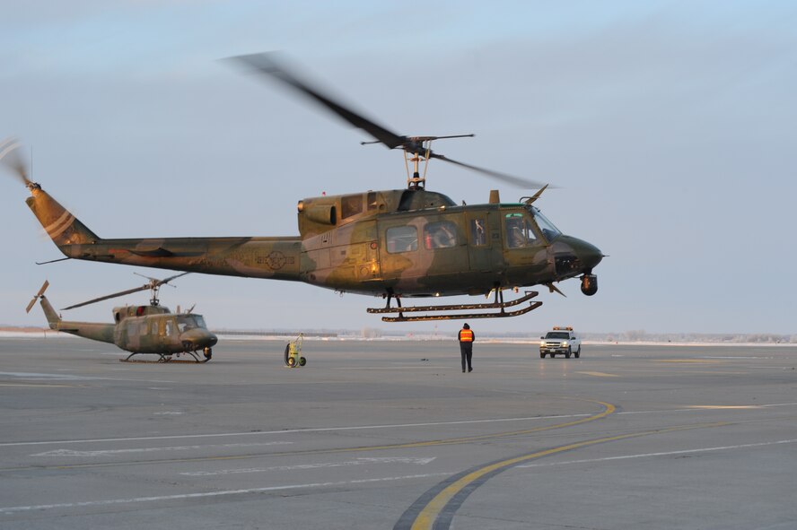 The 54th Helicopter Squadron at Minot Air Force Base, N.D. take off from Grand Forks AFB, N.D. to begin preparations for search and rescue missions of the Red River Valley. (U.S. Air Force photo/Tech. Sgt. Johnny Saldivar)