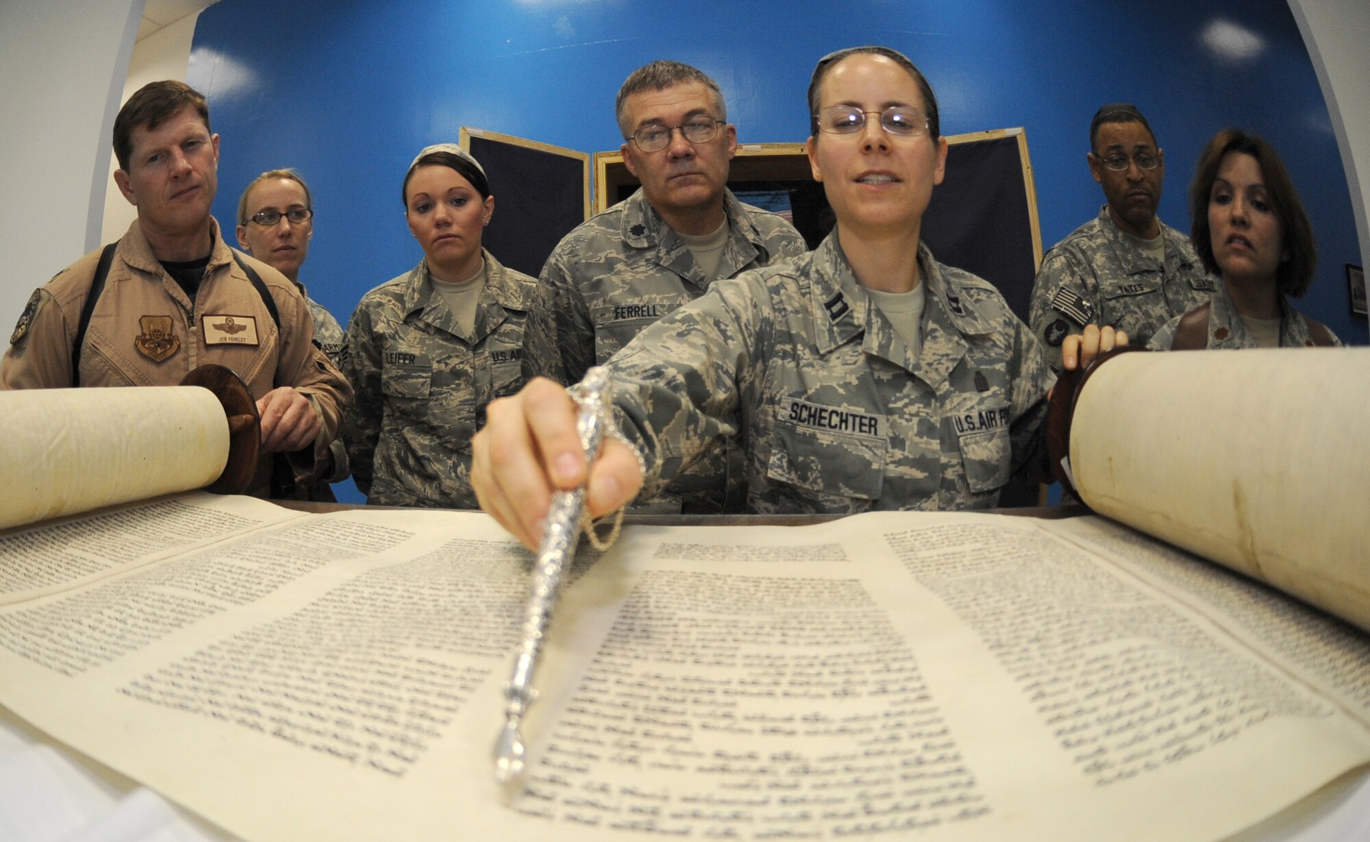 JOINT BASE BALAD, Iraq -- Chaplain (Capt.) Sarah Schechter, 332nd Air Expeditionary Wing rabbi, describes the newly arrived Jewish Torah following a Torah dedication ceremony at Gilbert Memorial Chapel here March 21. A Torah is a big parchment leather scroll on which the Five Books of Moses are handwritten in Hebrew. For thousands of years, this is how Jews have maintained their law, teachings, religion and society. (U.S. Air Force photo/Senior Airman Elizabeth Rissmiller)