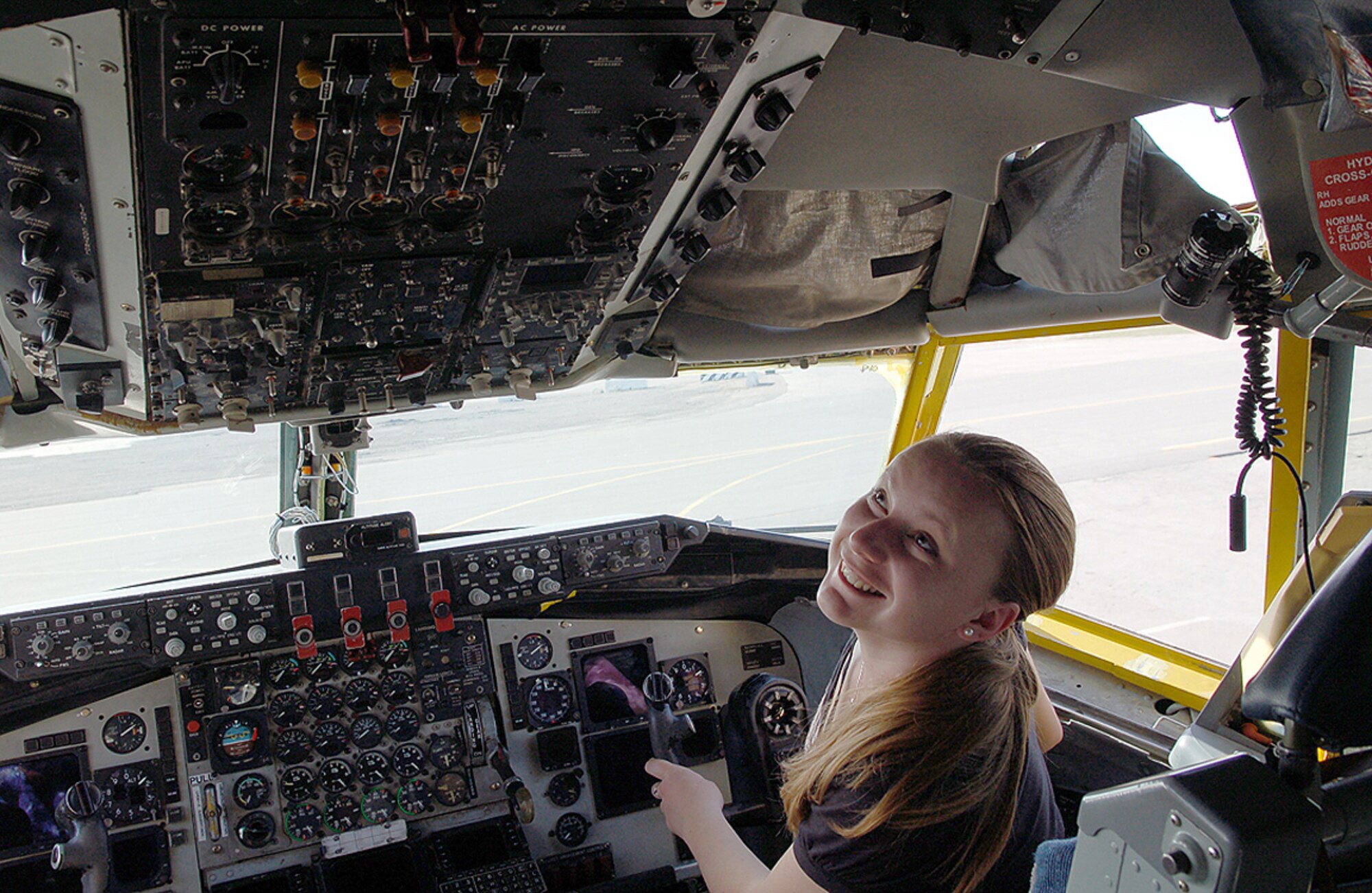 Alesia Bulankina, an American University of Central Asia student, checks out myriad knobs, dials and switches in the cockpit of a KC-135 Stratotanker at Manas Air Base, Kyrgyzstan, March 26. Ms. Bulankina, a 20-year-old junior from Bishkek who is majoring in business administration, visited Manas with 12 other students and faculty for an orientation tour and dinner hosted by the 376th Air Expeditionary Wing Public Affairs office. The visit provided the students a look at the missions carried out daily in support of operations in Afghanistan, while building friendships with coalition personnel deployed here. (U.S. Air Force/Tech. Sgt. Phyllis Hanson) 